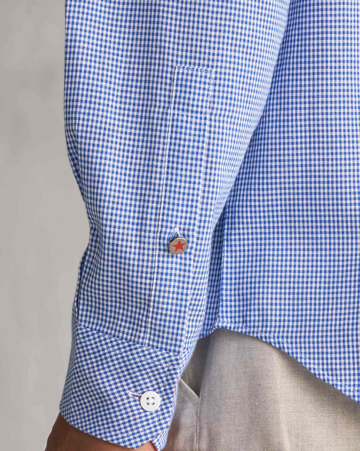 Close-up of the Bias Placket Shirt cuff with a red star button.