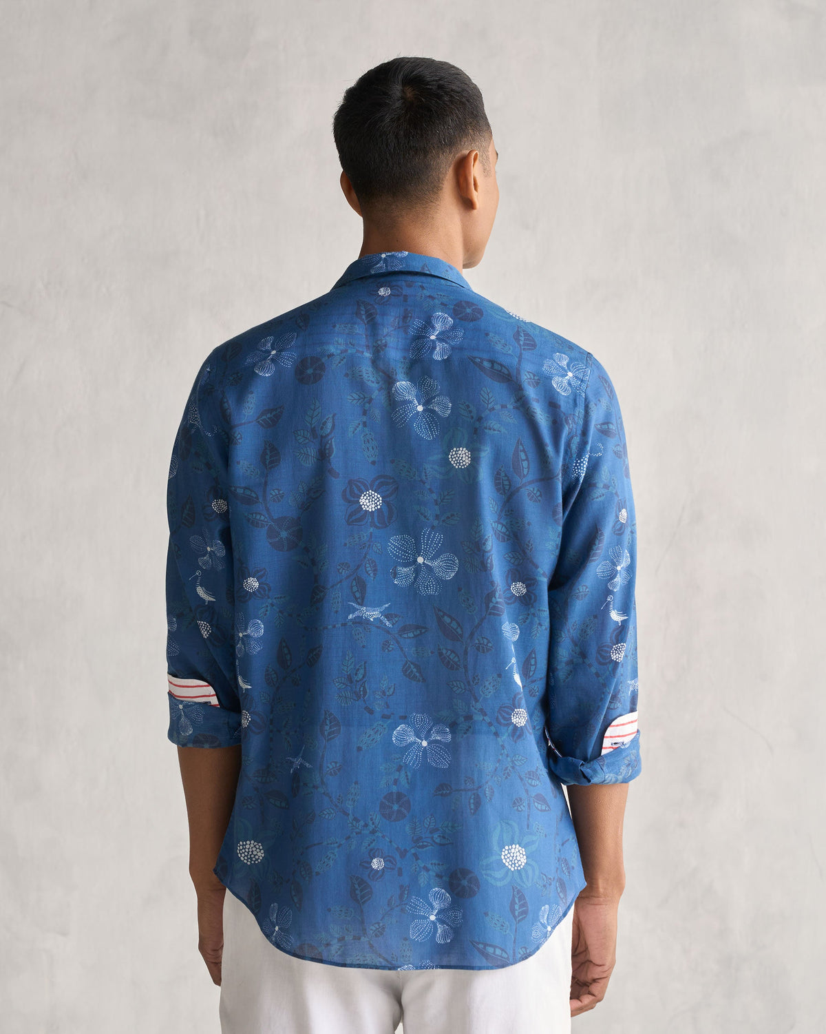 Back of a navy Hakuna Shirt worn by a person.