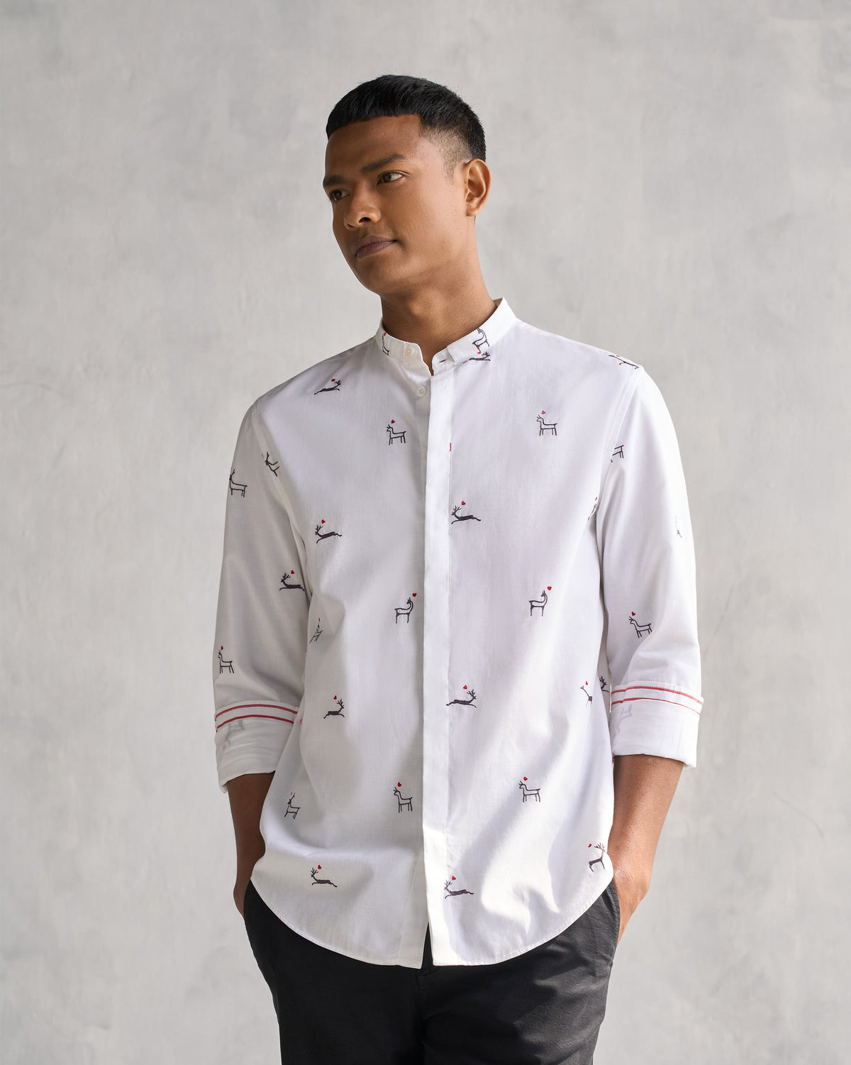 Person wearing a white Classic Band Collar Shirt with embroidered deer.
