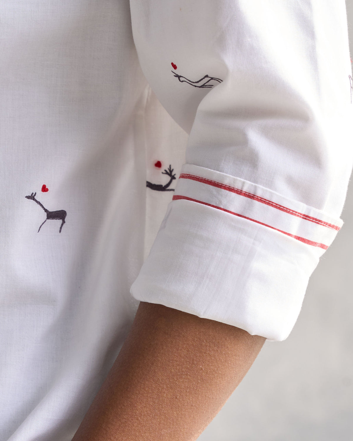 Close-up of the Classic Band Collar Shirt's cuff, showing red stripe trim.