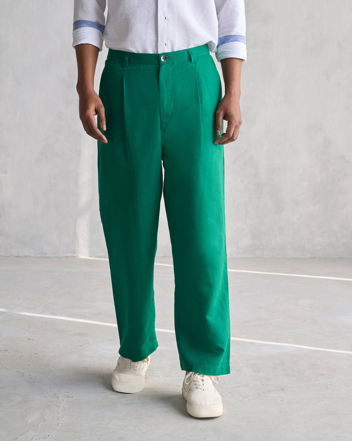Person wearing green Pleated Pants with front pleats.