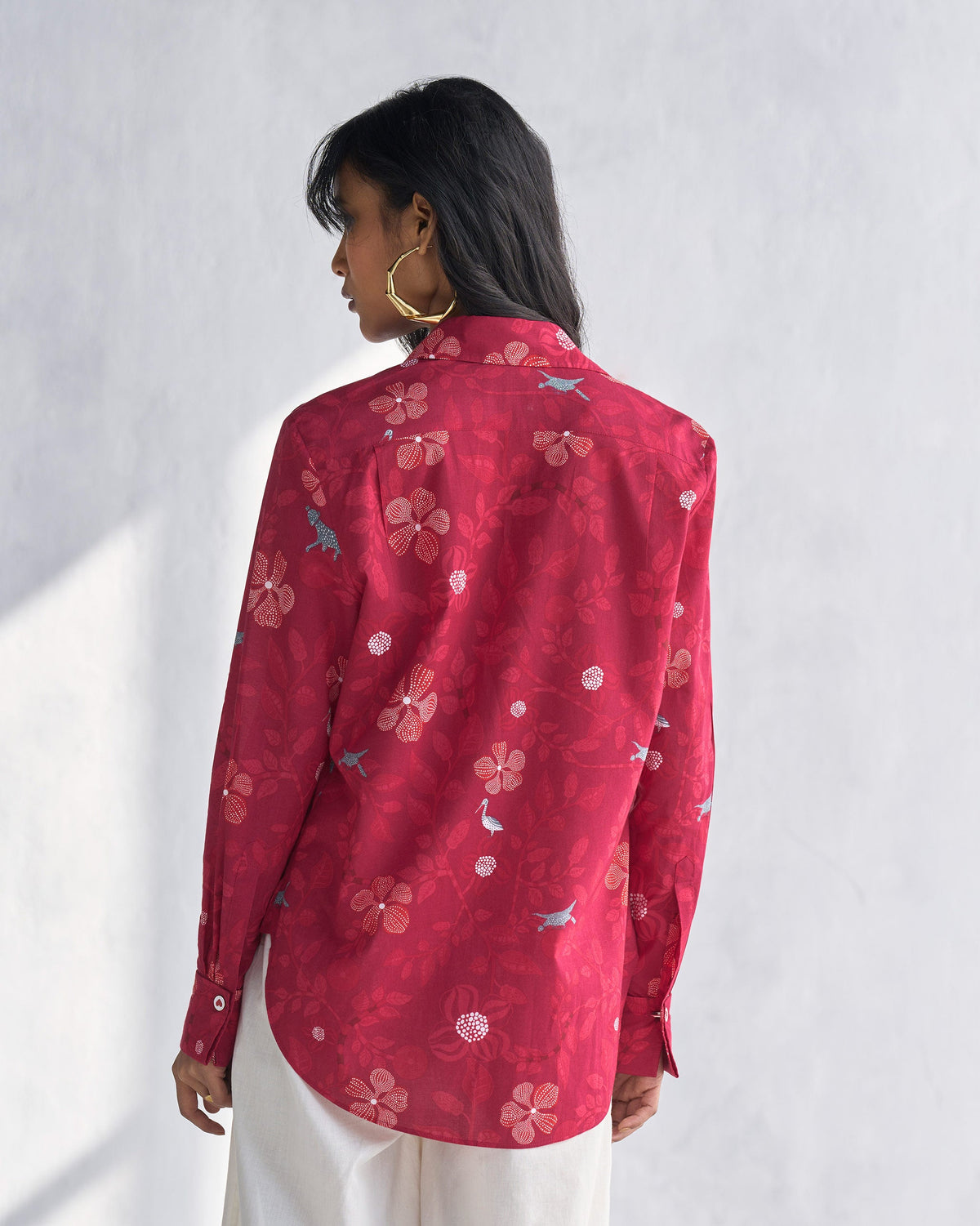 Back of a Tropico Shirt worn by a person, with a floral print and small birds.