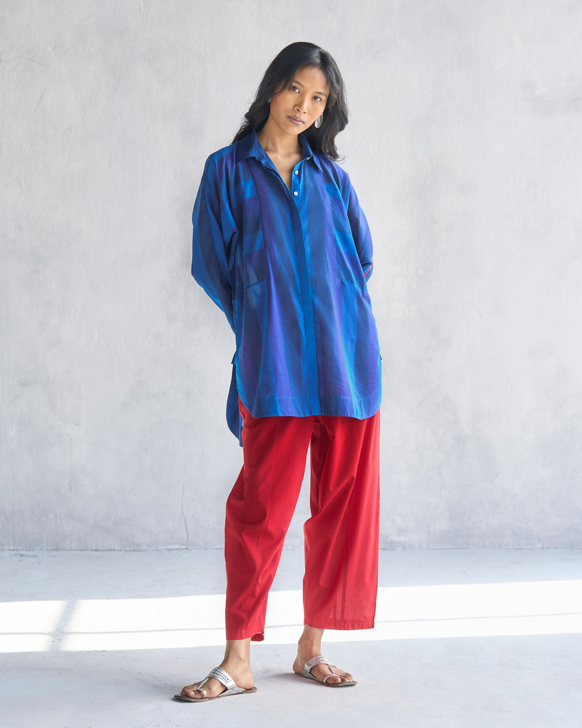 Person standing in a navy and blue Sugato Panelled Shirt.