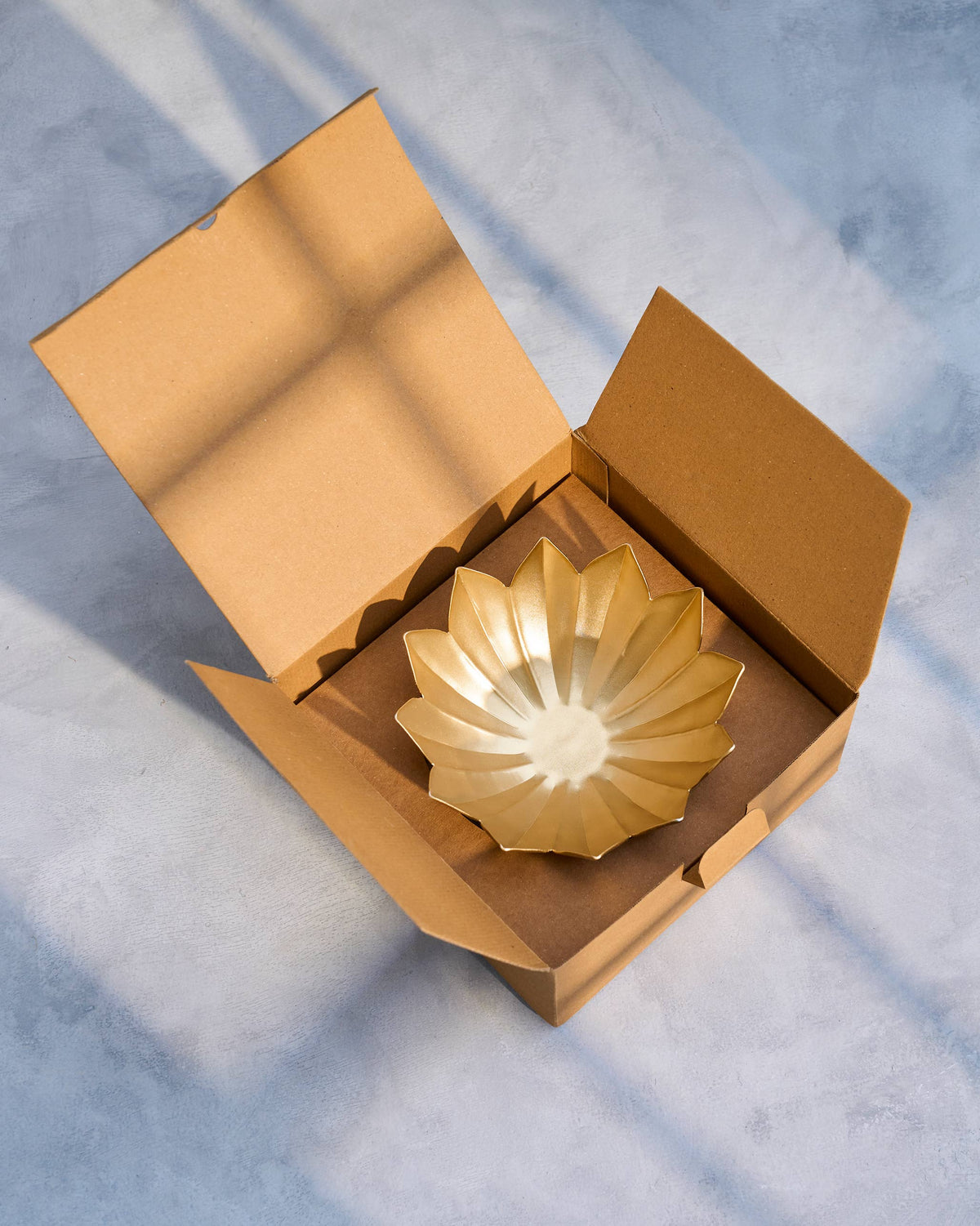 Bloom Deco Bowl resting inside an open kraft box.