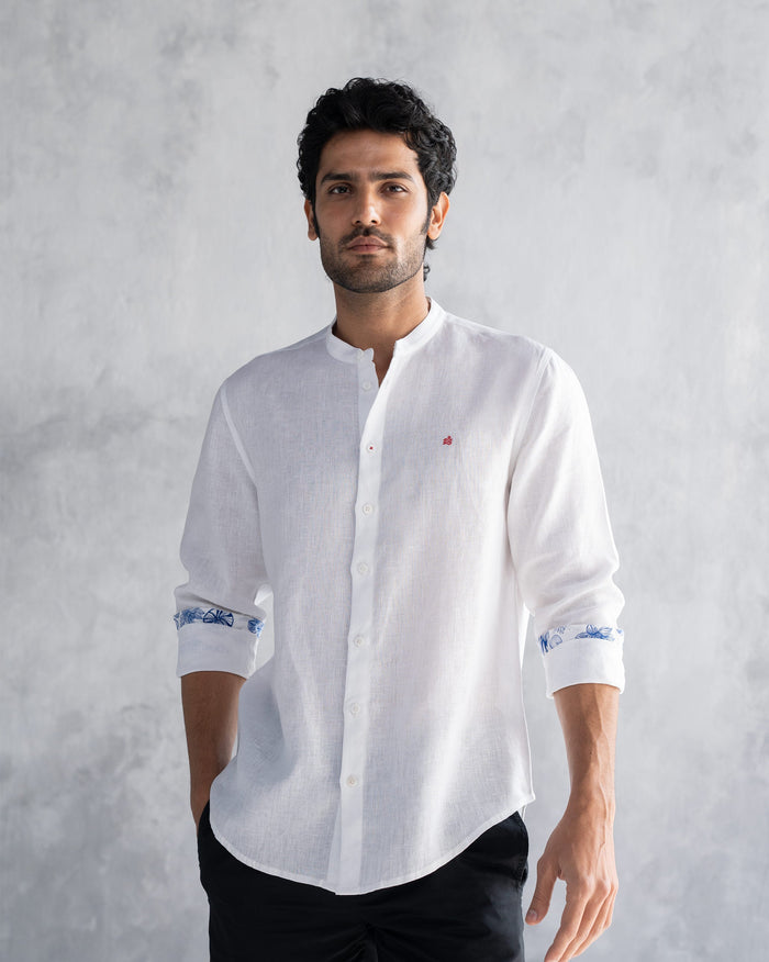 Person wearing a white Nawab shirt with a Nehru collar and red logomark.