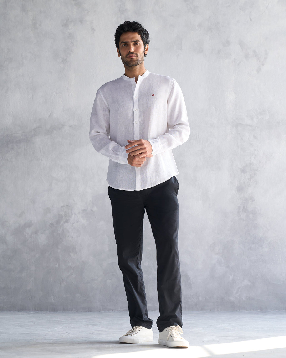 Person wearing a white Nawab shirt with a Nehru collar.