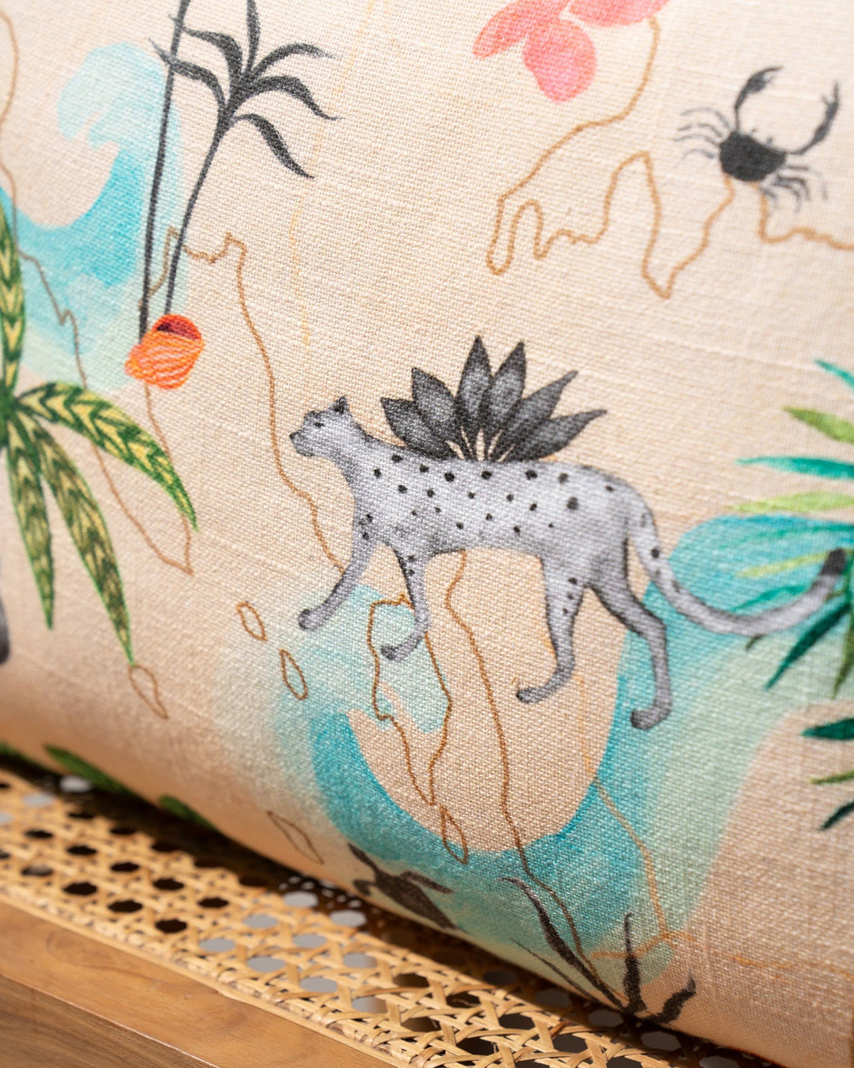 Close-up of the Safari Trail Cushion Cover print with a spotted animal and a crab.