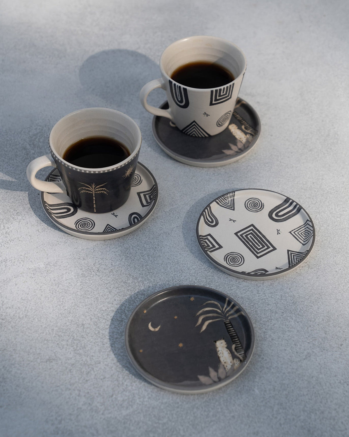 Serenity Coasters arranged on a table beside two coffee cups.