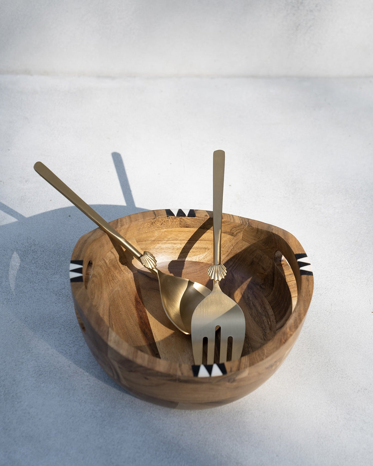 Zanzibar Salad Bowl with triangle inlay around its rim, shown at eye level.