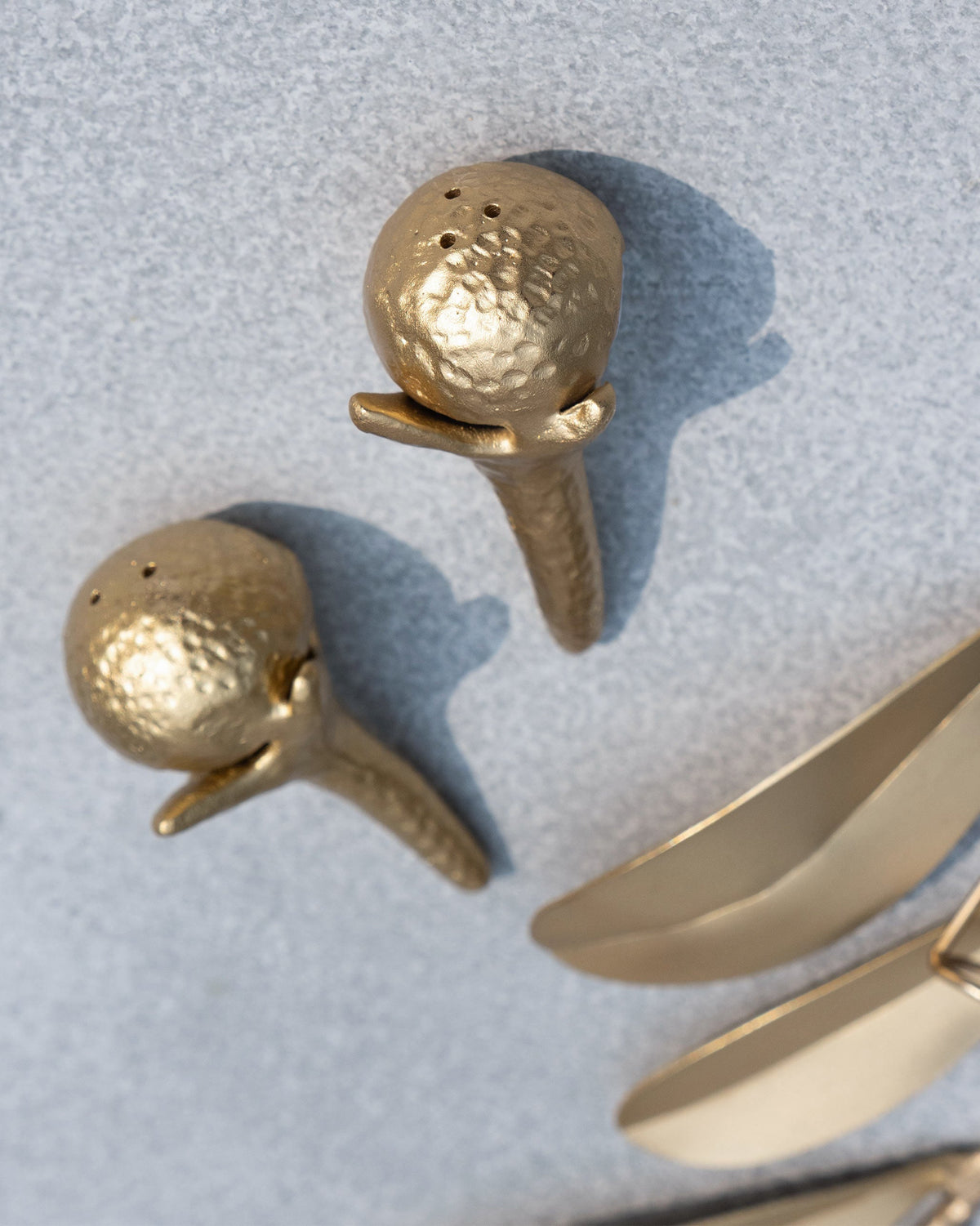 Pair of gold Clove Salt and Pepper Shakers shaped like clove buds.