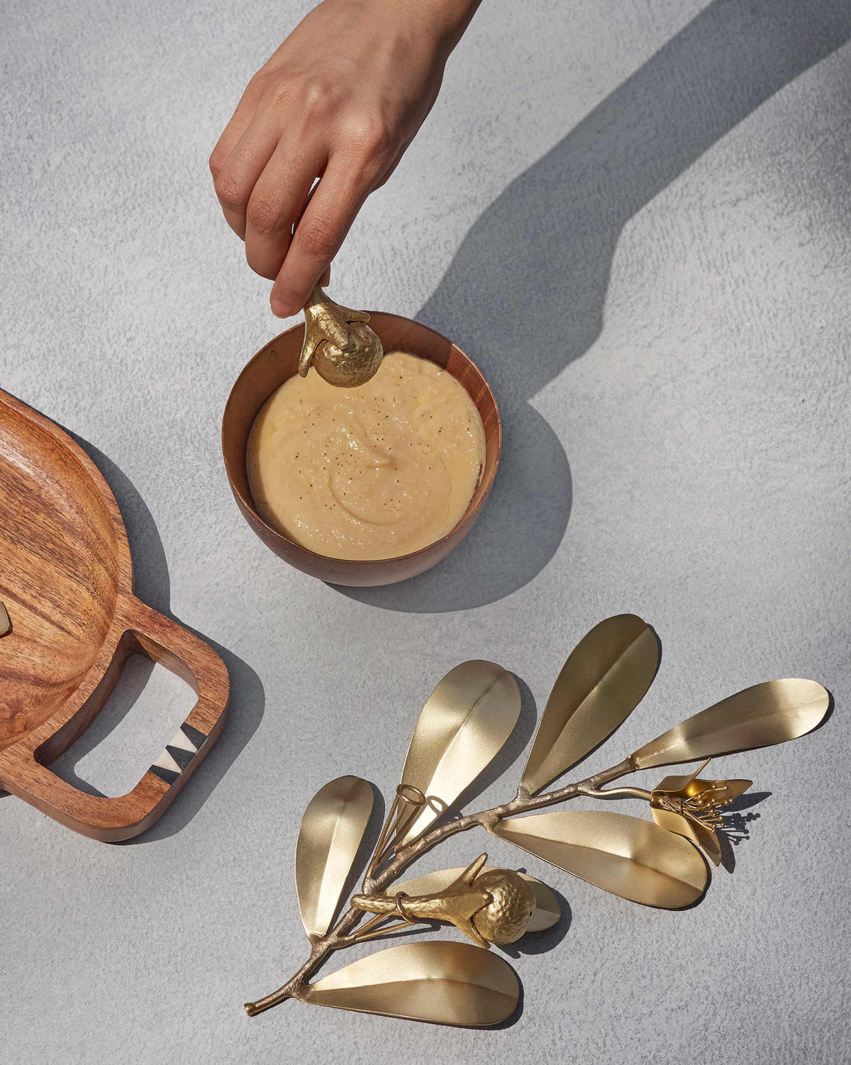 Gold Clove Salt and Pepper Shaker set used with a leafy brass holder.