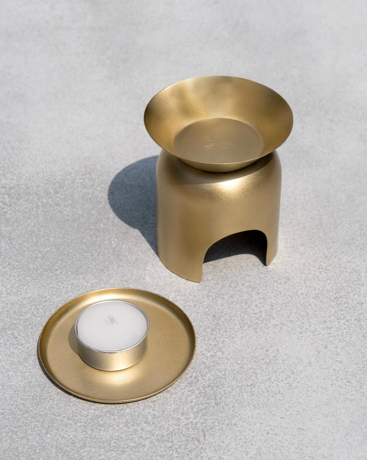 Gold Clove Diffuser beside its tealight and tray.