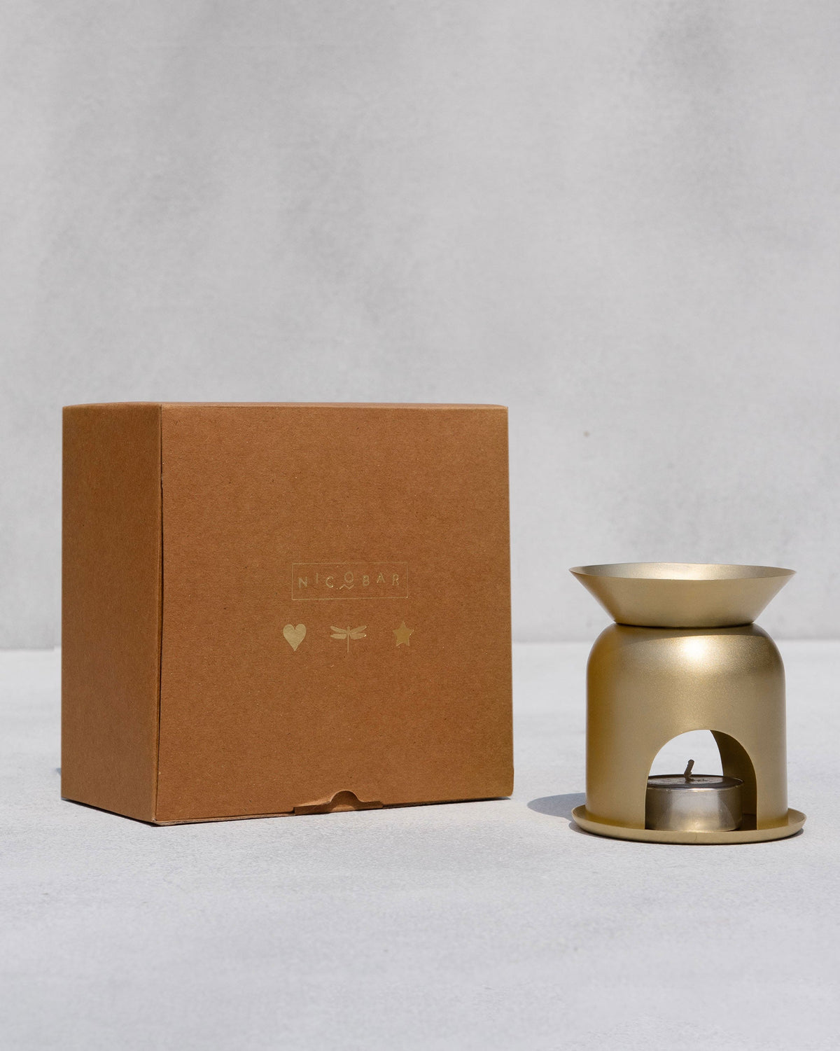 Gold Clove Diffuser beside its kraft gift box.