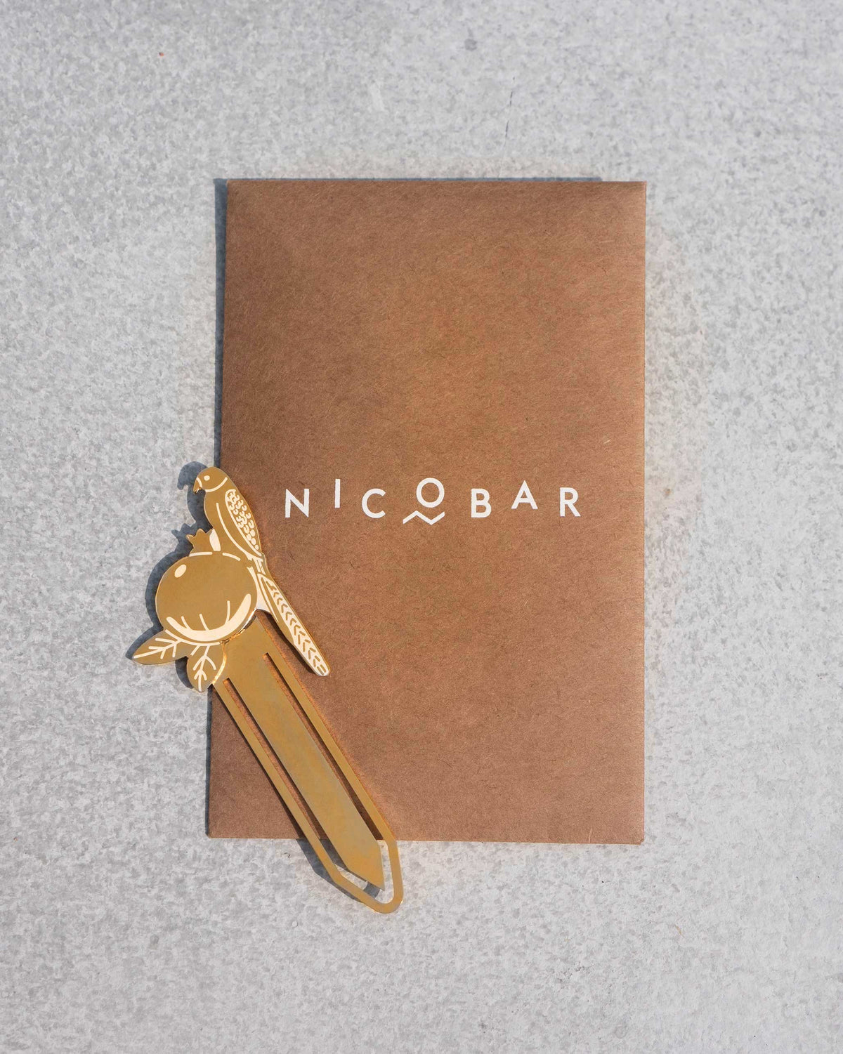 Safari Tota Bookmark resting on a brown Nicobar card.