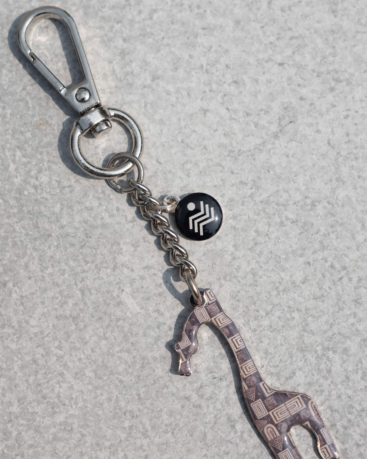 Close-up of the Giraffe Keychain showing its patterned giraffe charm.