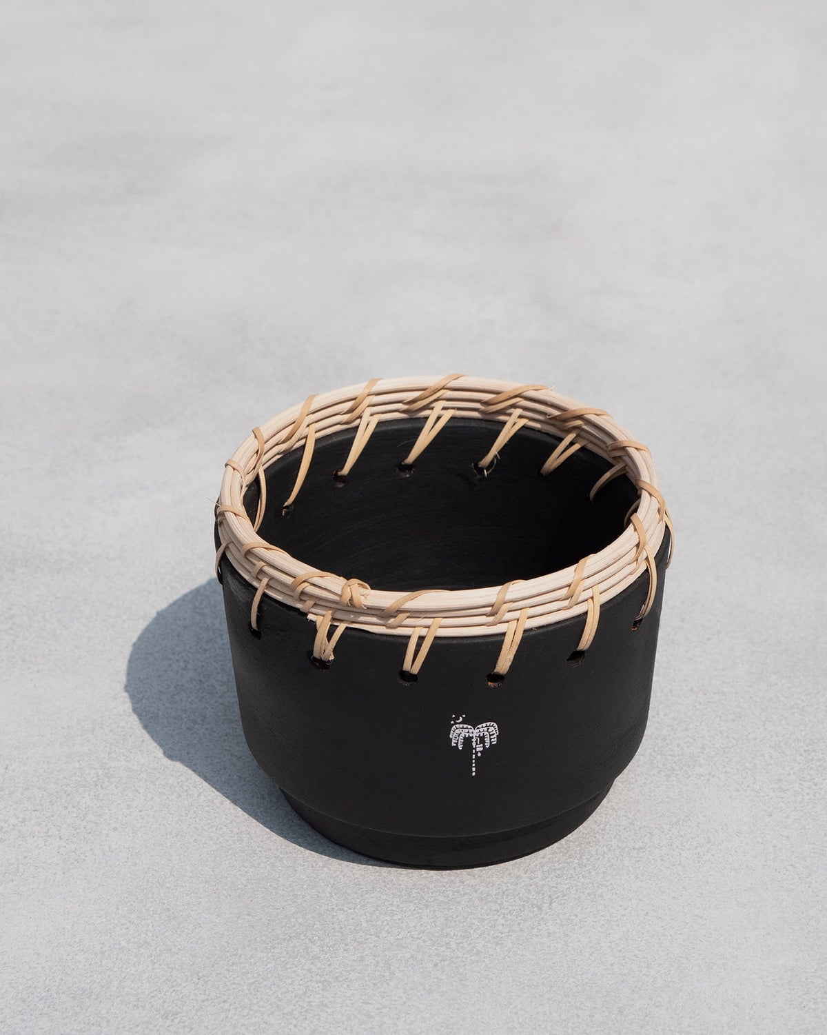 Overhead view of a Zanzibar Planter showing its inside and rattan rim.