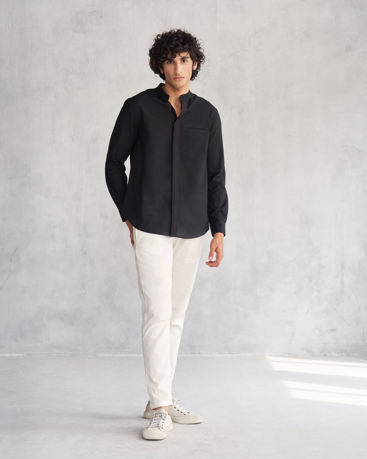 Full-length view of a black Valley shirt worn by a person.