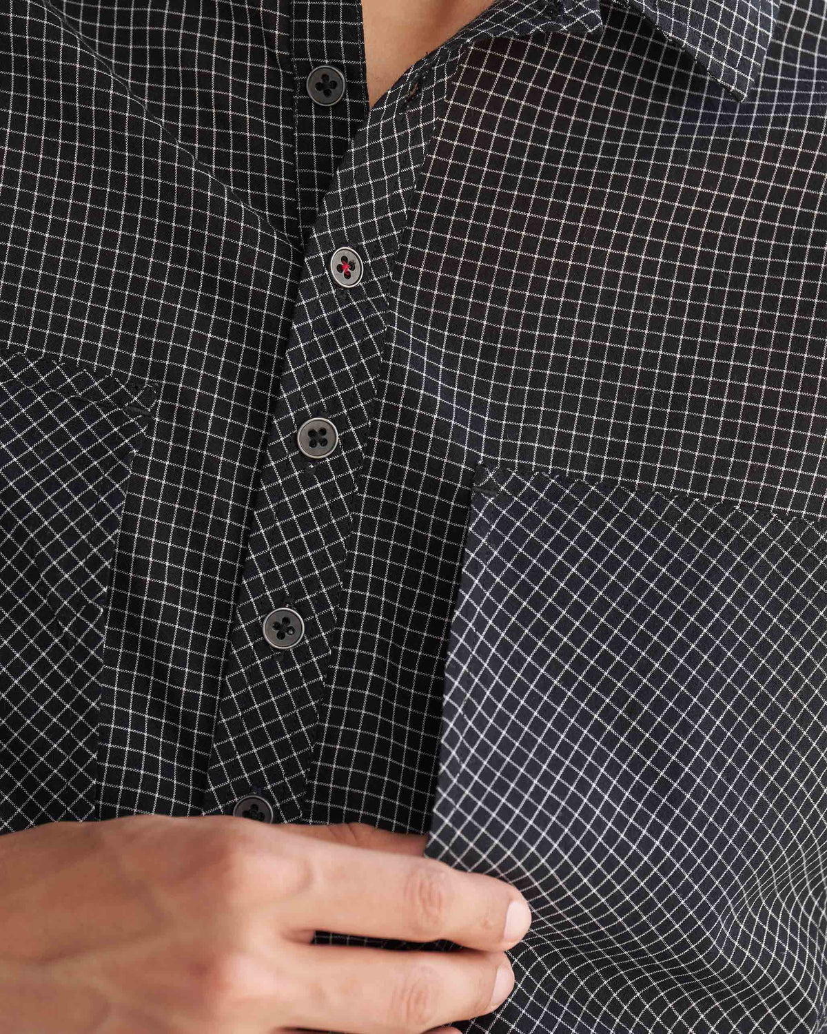 Close-up of the Big Pocket shirt, showing its fine white grid check and chest pocket.