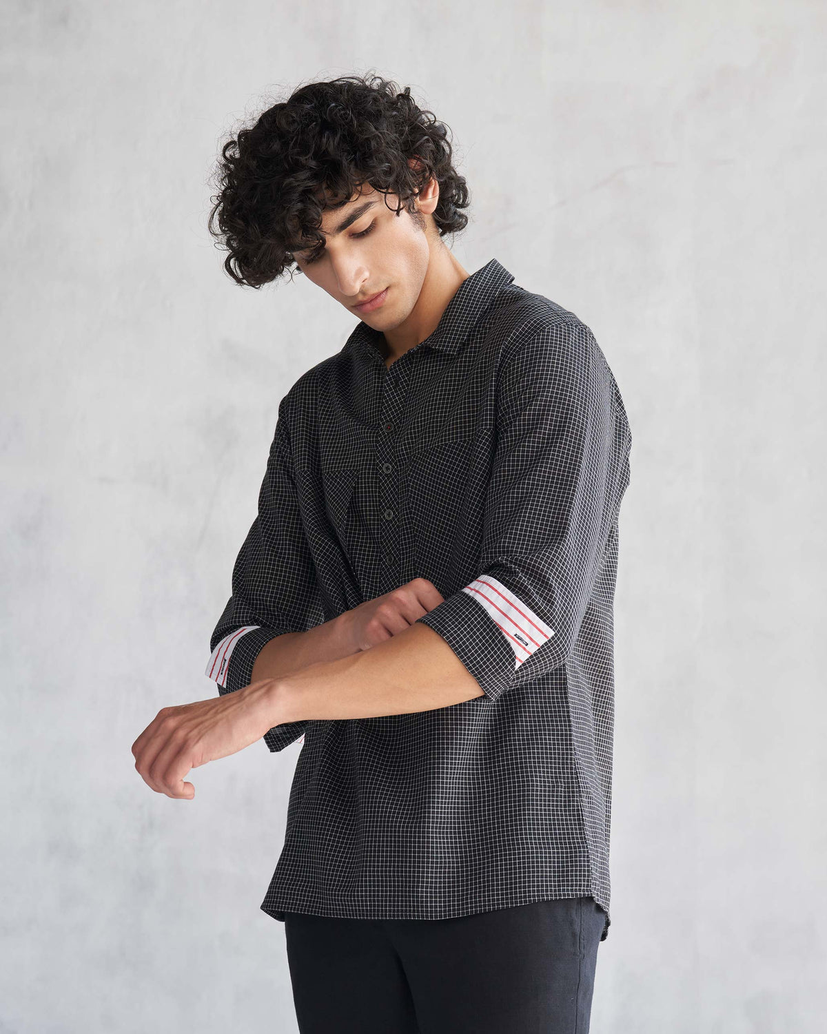 Person wearing the Big Pocket shirt with sleeves rolled, showing the striped cuffs.