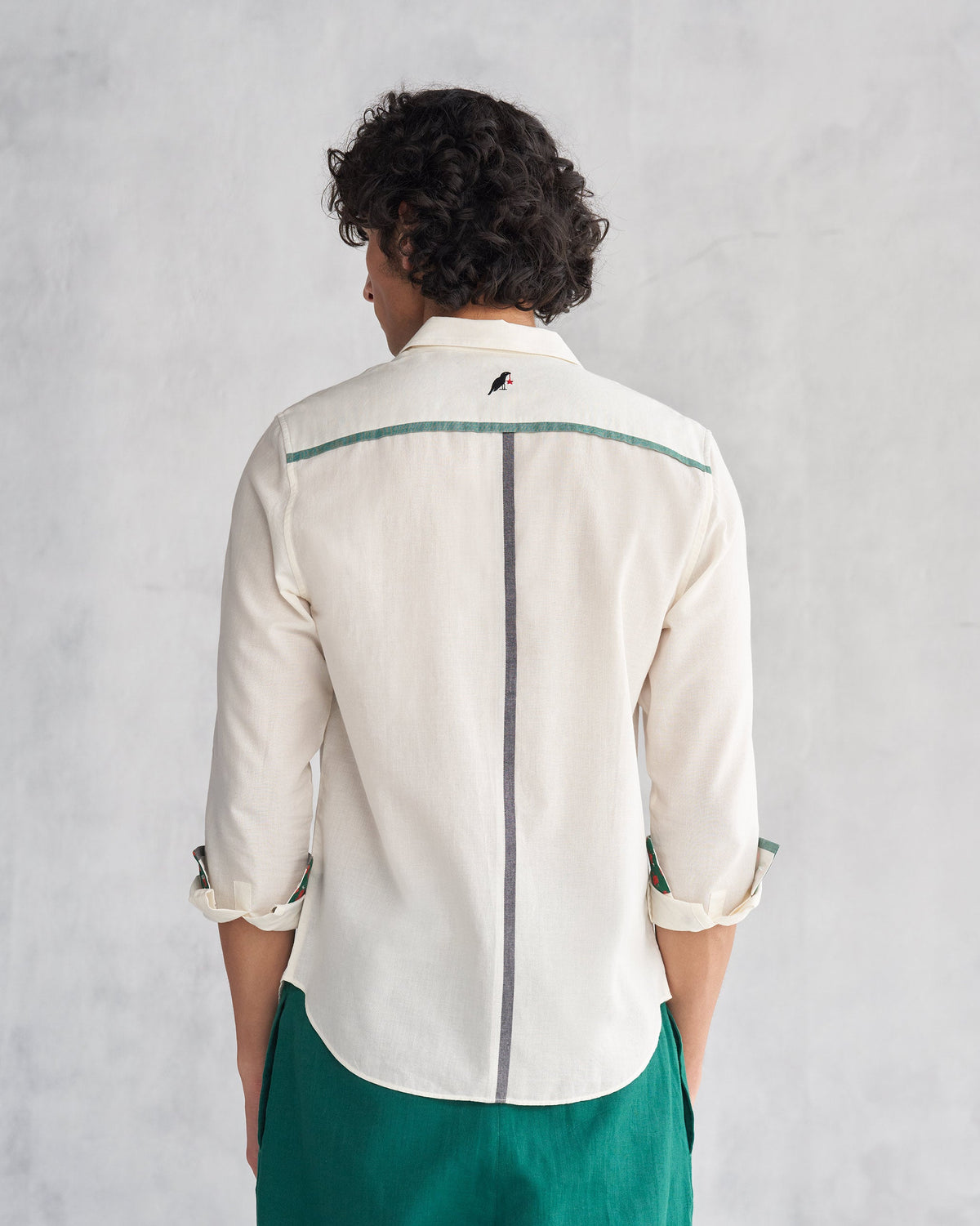 Back of an ivory Kangra Shirt with bird embroidery worn by a person.