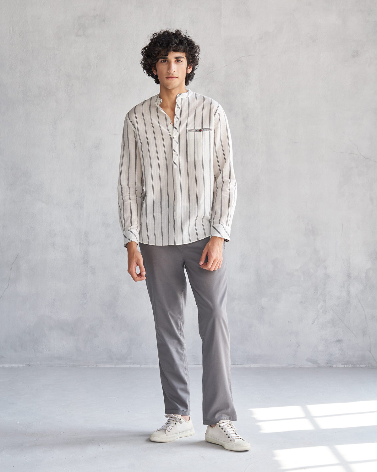 Person wearing an ivory and black Pondicherry shirt, shown full length.