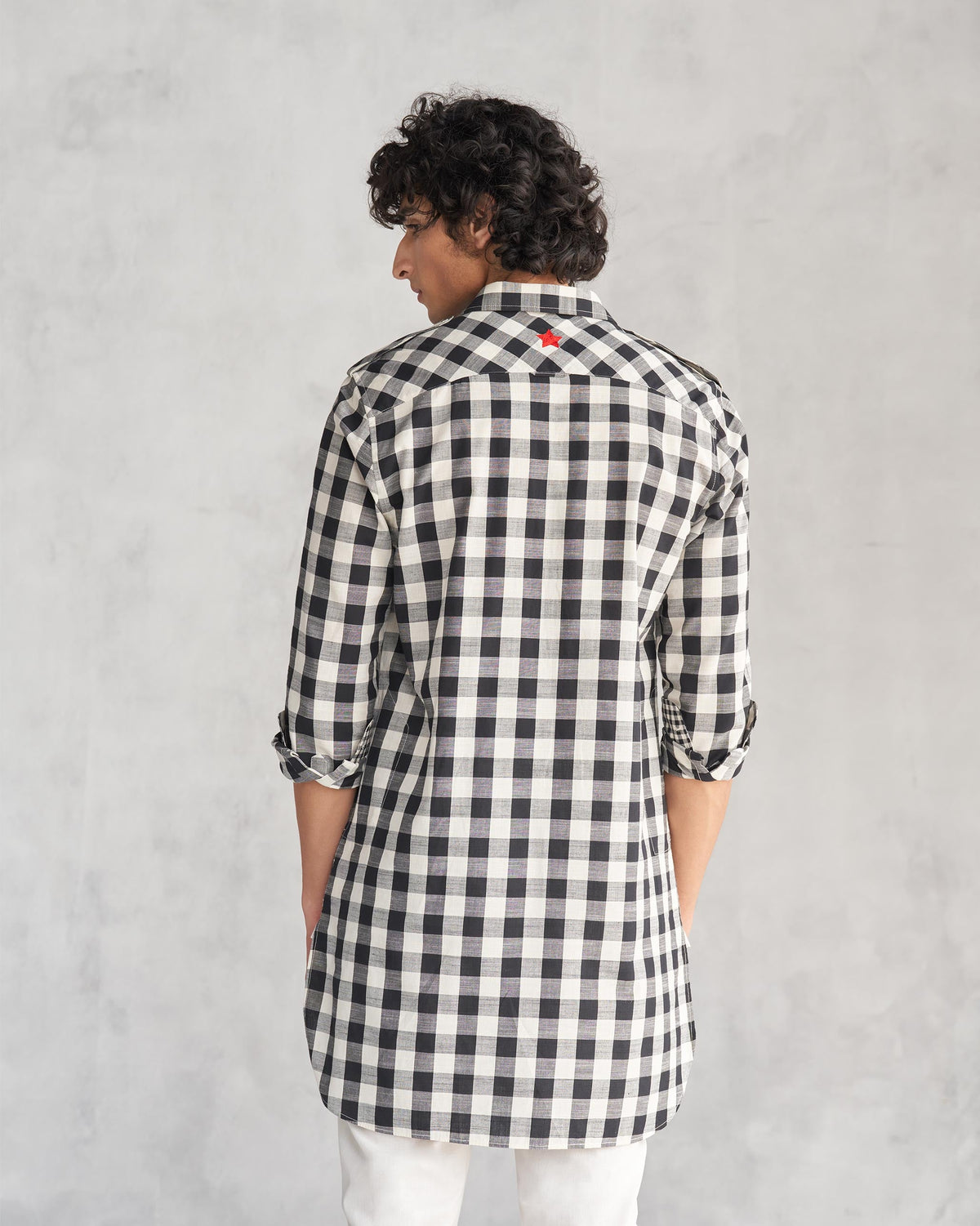 Back of a black and ivory checked Nizamuddin kurta worn by a person.