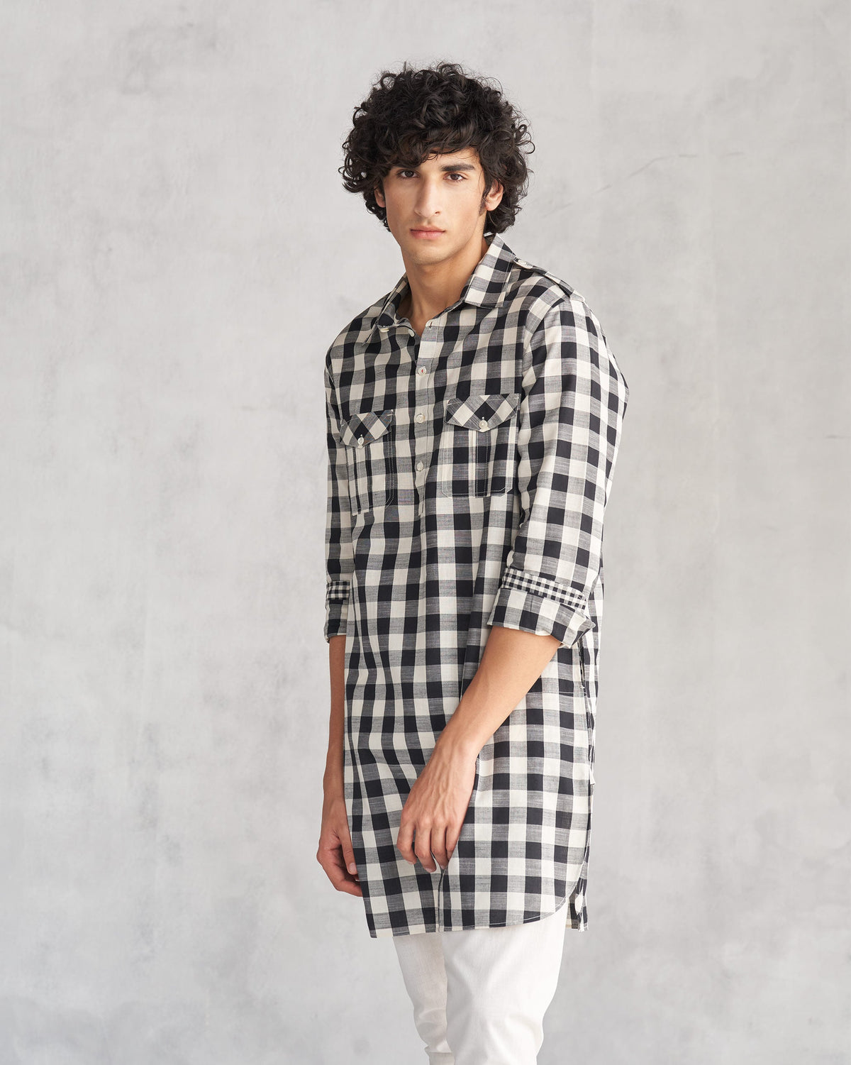 Side view of a black and ivory checked Nizamuddin kurta worn by a person.