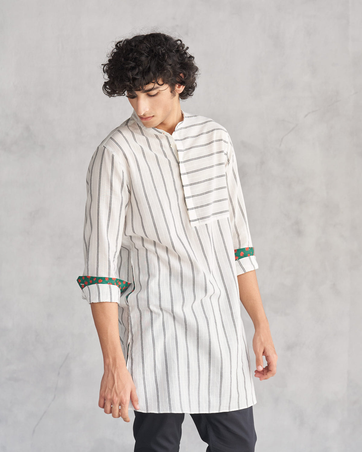 Person wearing an ivory and black Panel Stripe Kurta with a striped chest panel.