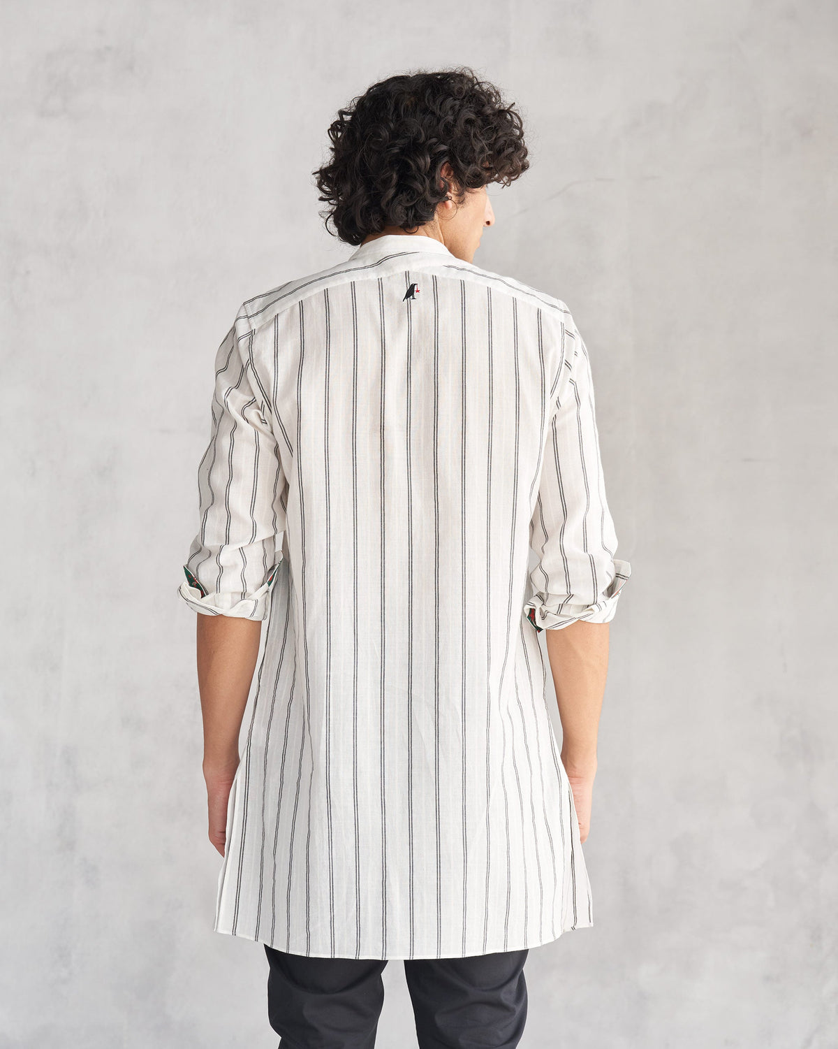 Back of an ivory and black Panel Stripe Kurta worn by a person.