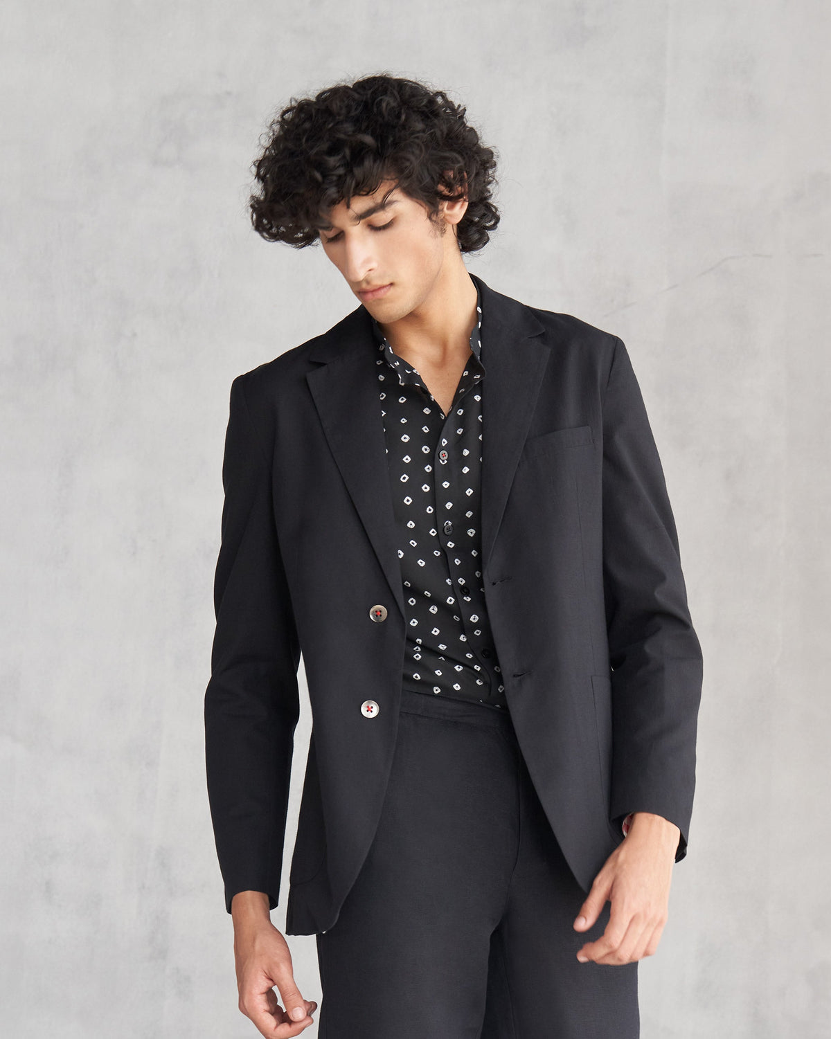 Person wearing a black Midnight Marvel Jacket with two buttons.