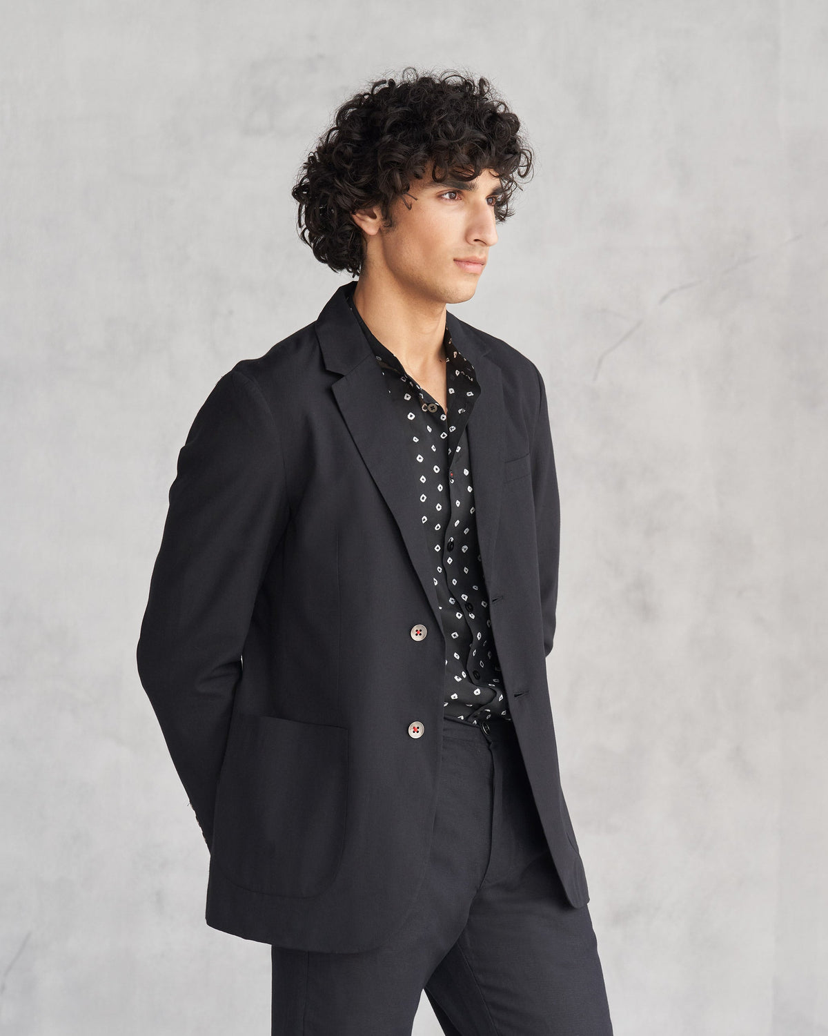 Side view of a black Midnight Marvel Jacket worn by a person.
