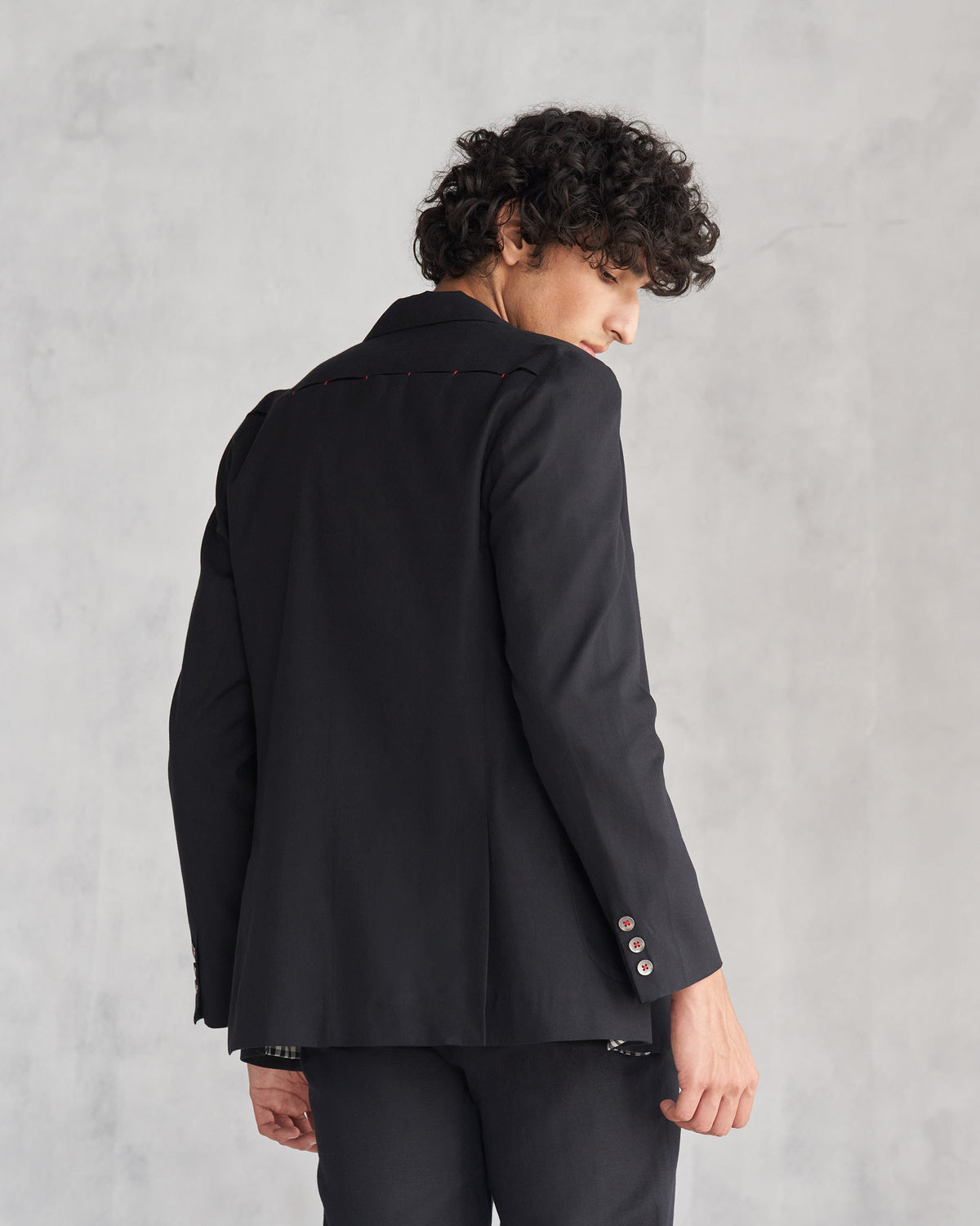 Back of a black Midnight Marvel Jacket worn by a person.
