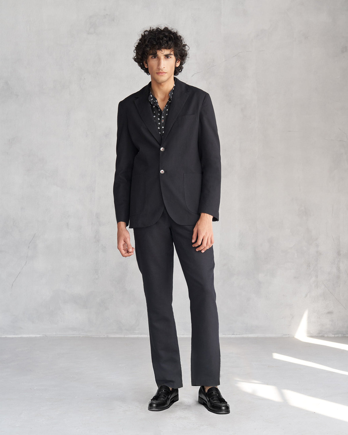Full-length view of a black Midnight Marvel Jacket worn by a person.