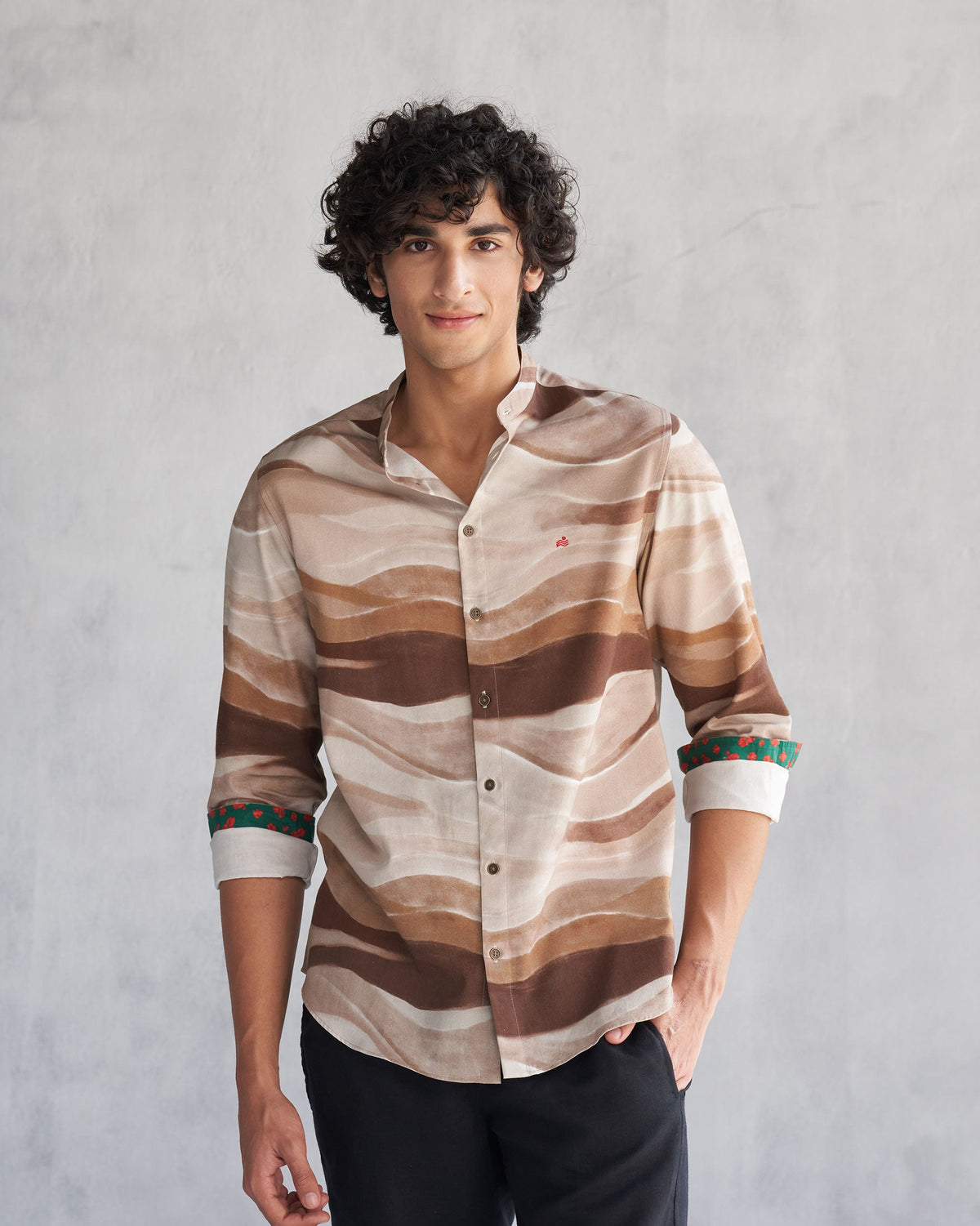 Person wearing a brown wave print Nawab shirt.