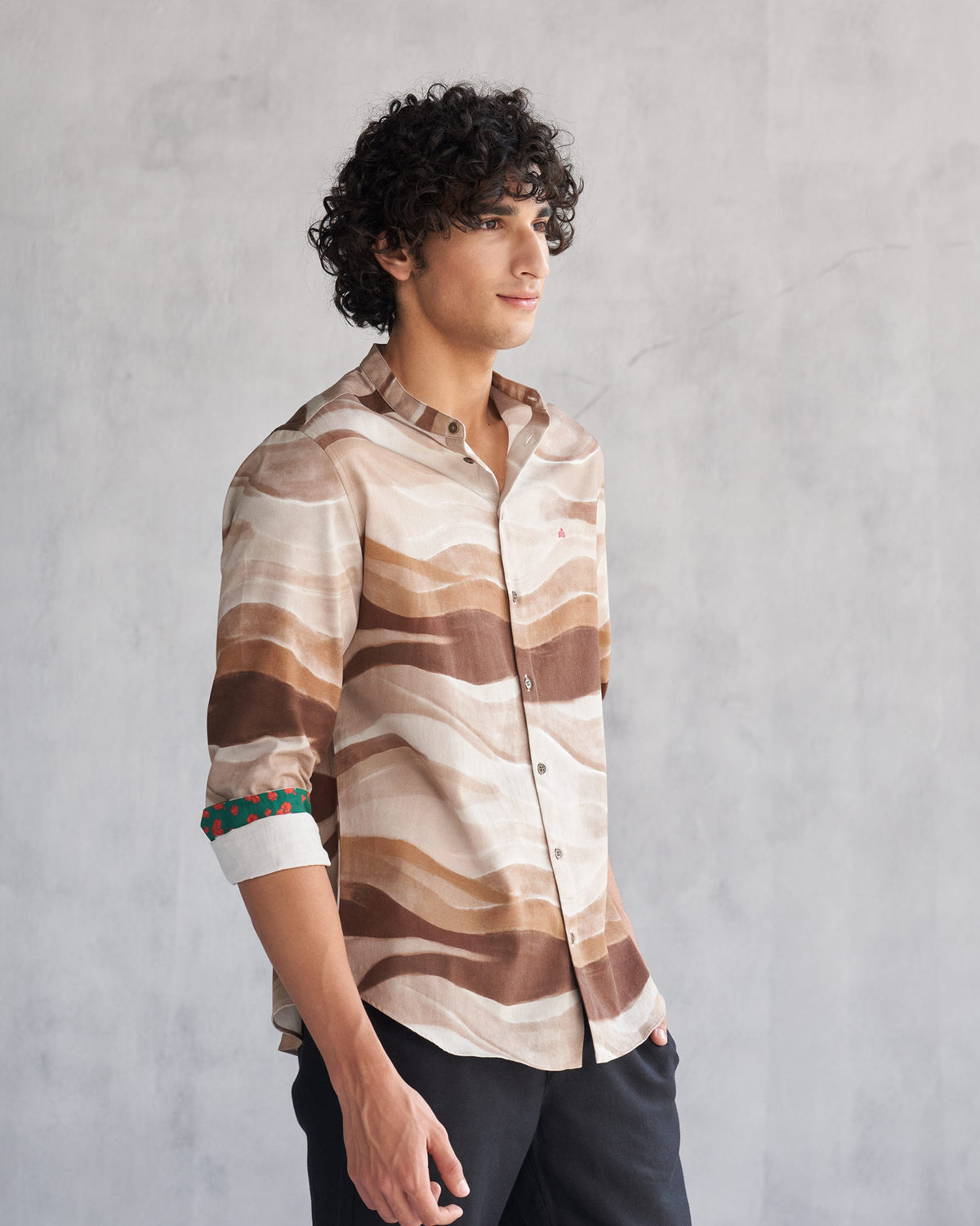 Side view of a brown wave print Nawab shirt worn by a person.