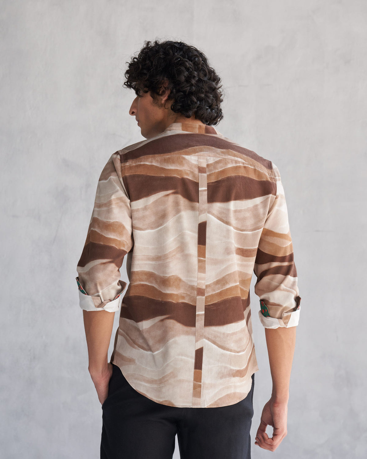 Back of a brown wave print Nawab shirt worn by a person.