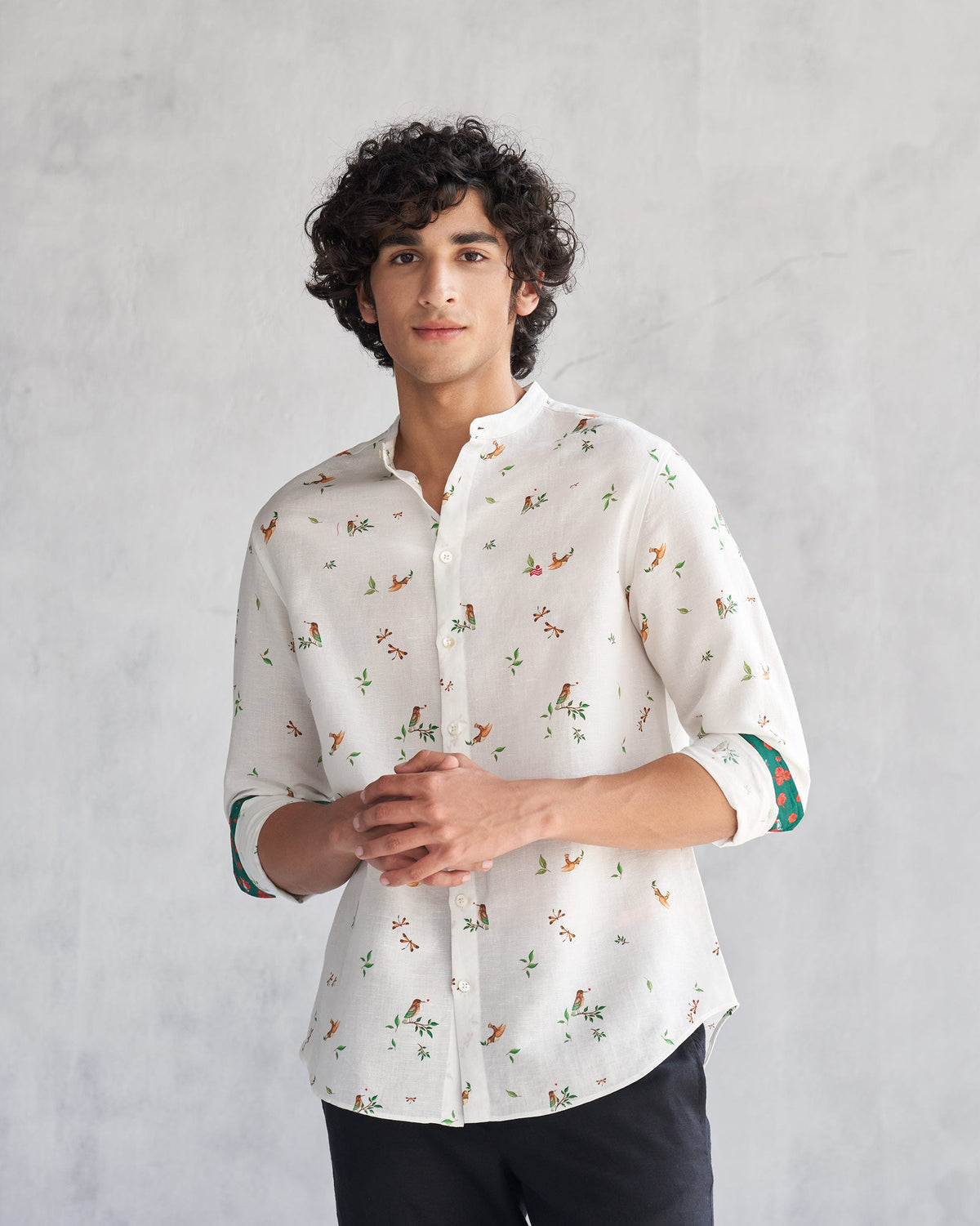 Person wearing a white Nawab Shirt with a bird and leaf print.