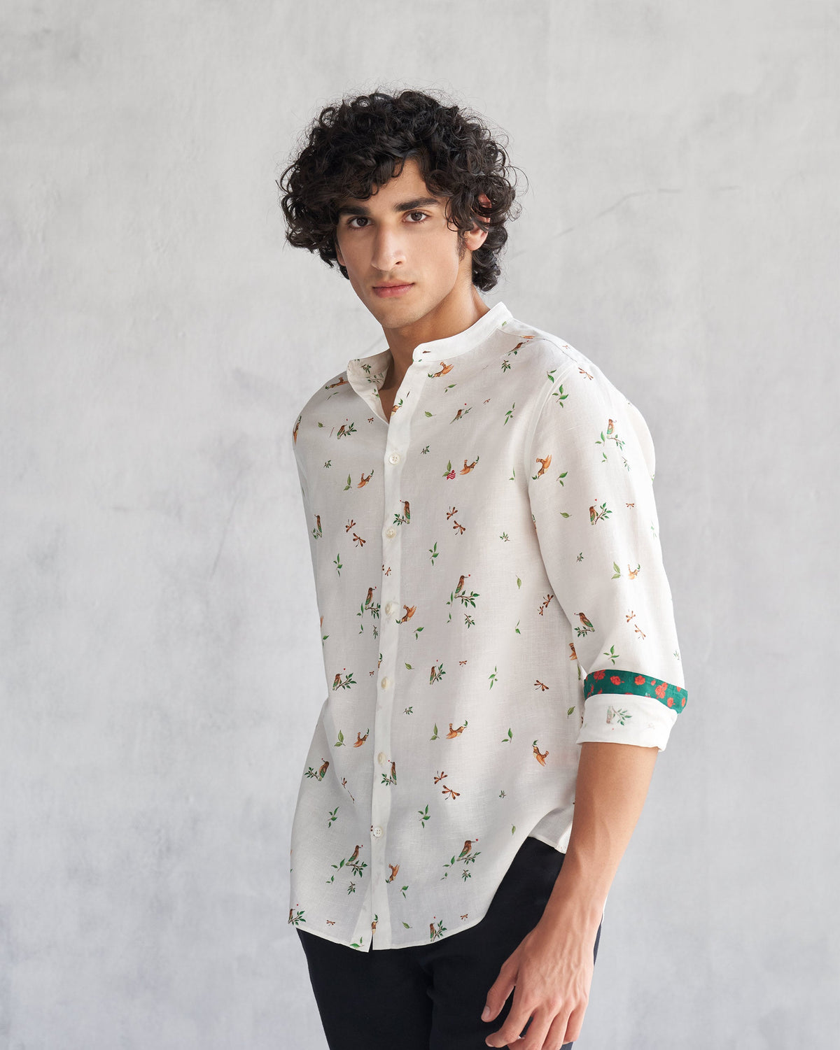 Side view of a white Nawab Shirt with green cuff trim worn by a person.