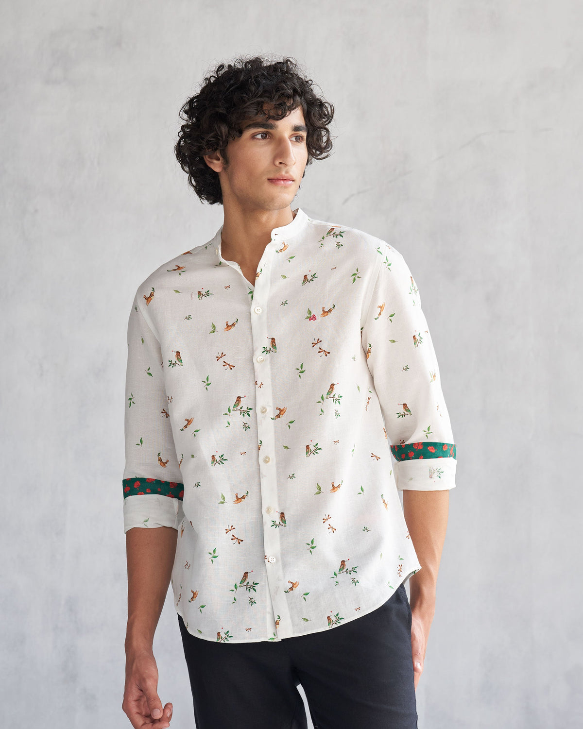 Person wearing a white Nawab Shirt with green cuff trim.
