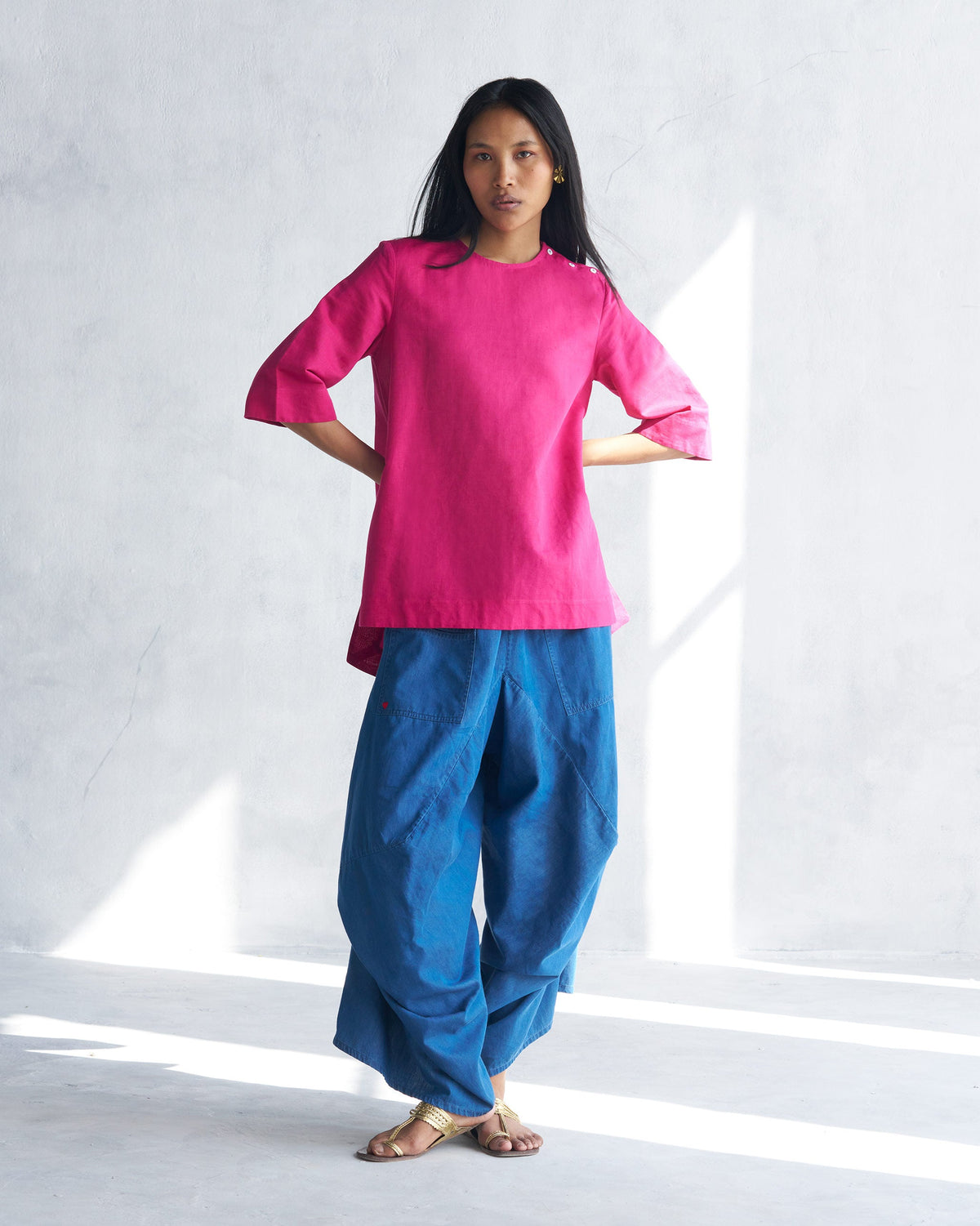 Person wearing a berry High Slit Top with a relaxed mid-thigh length.