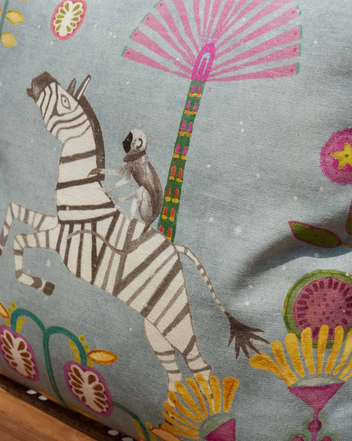 Close-up of the printed zebra and pink palm on a Zebra Cushion Cover.