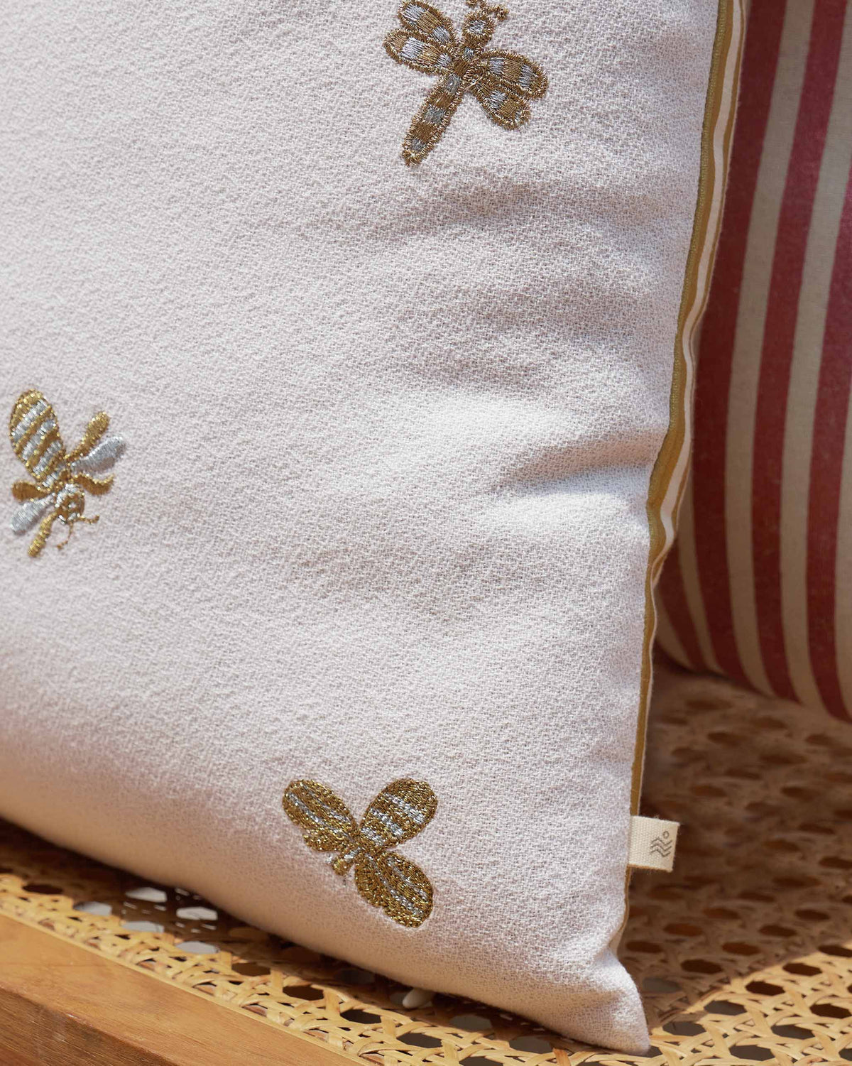Close-up of Honeybee Cushion Cover - Ivory showing embroidered bees.