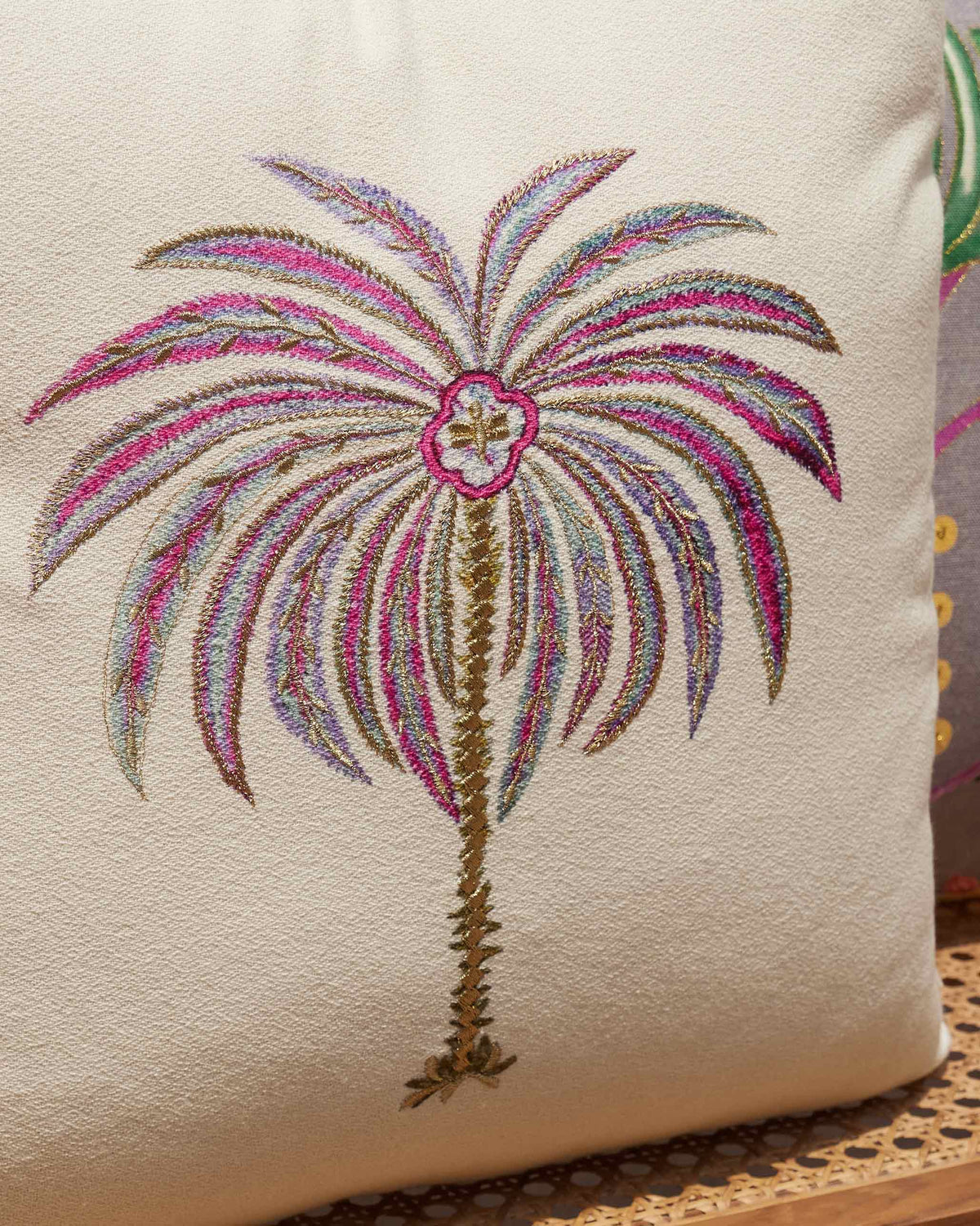 Close-up of the Zanzibar Palm Cushion Cover showing its embroidered palm tree.