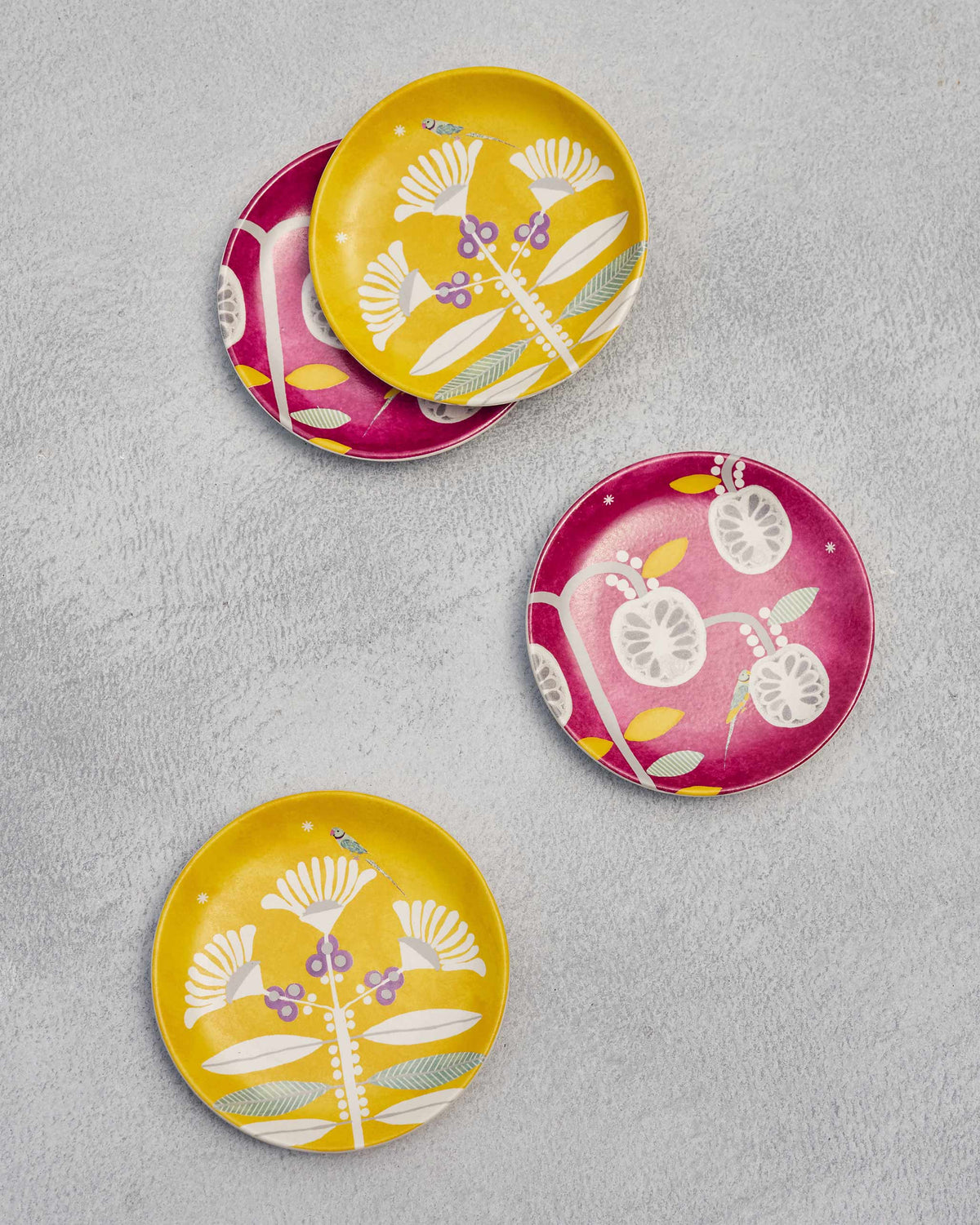 Bahari tea plates seen from above, showing pink and yellow flower designs.