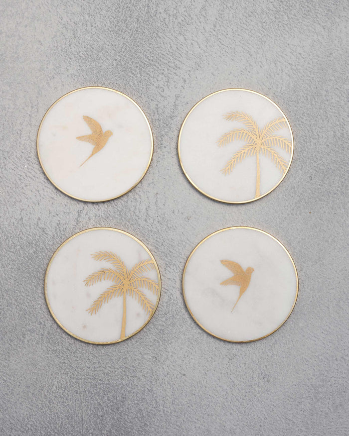 Coastline coasters (Set of 4) with gold palm and bird motifs.