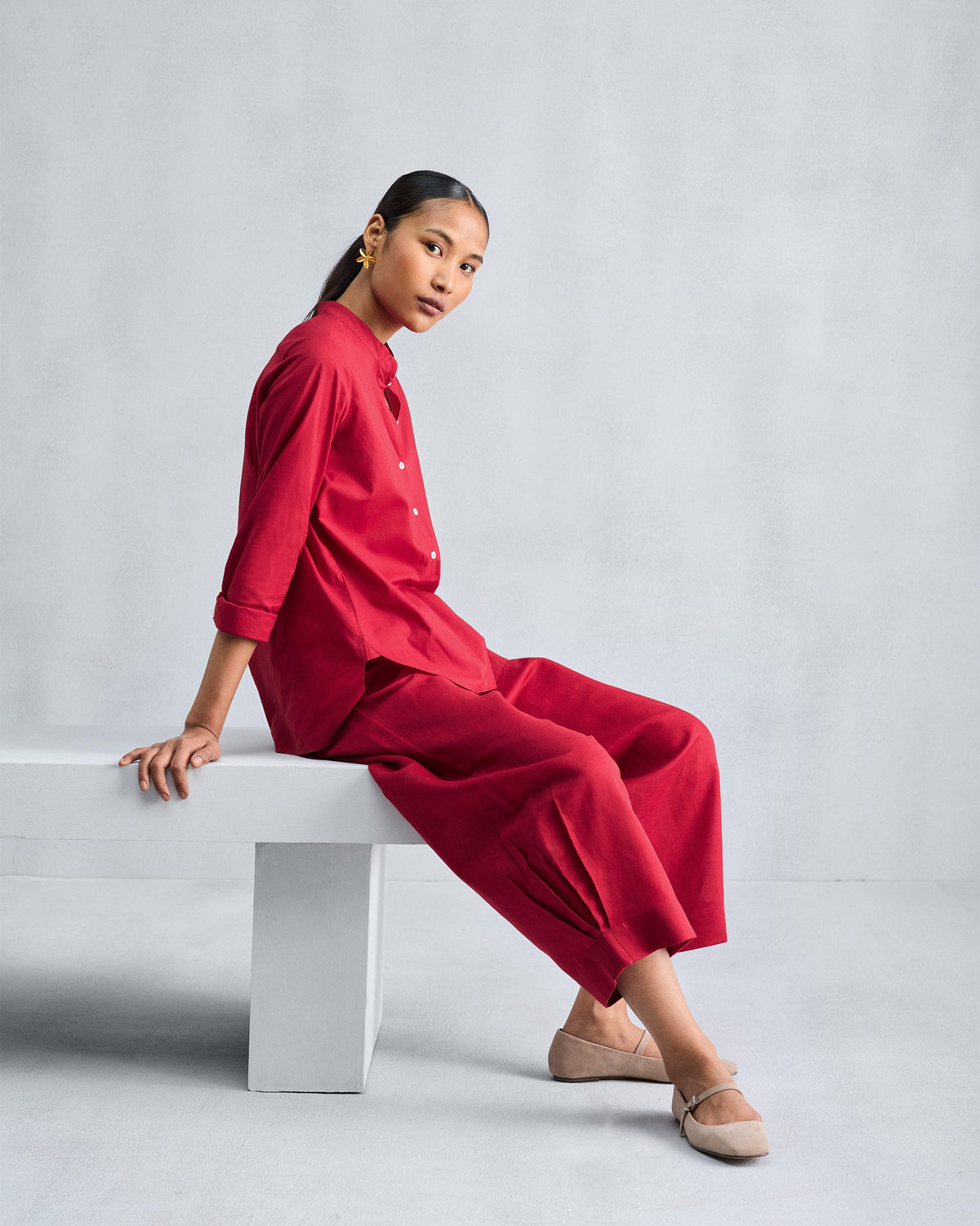 Person wearing red wide-leg cropped pants.