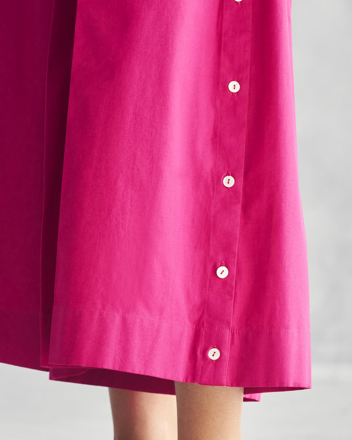 Close-up of Pleated Flare Culottes showing a row of white buttons down the side.