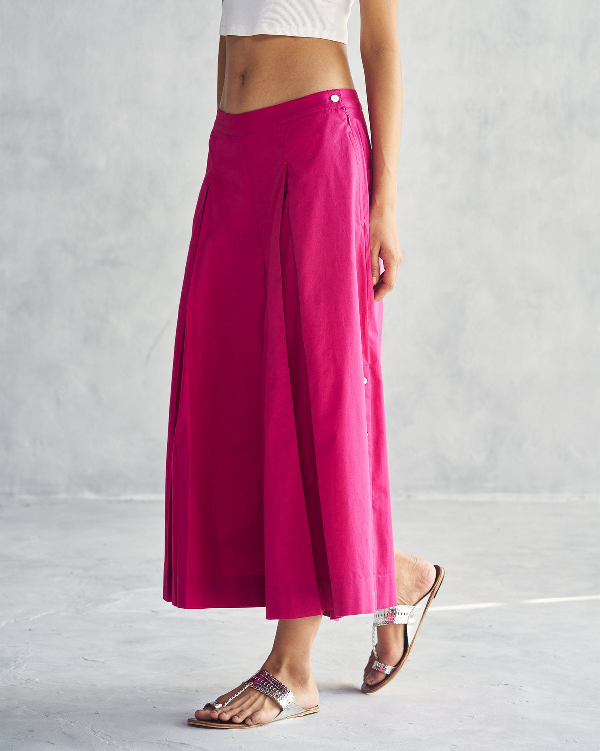 Side view of Pleated Flare Culottes in berry showing the pleated leg panel.