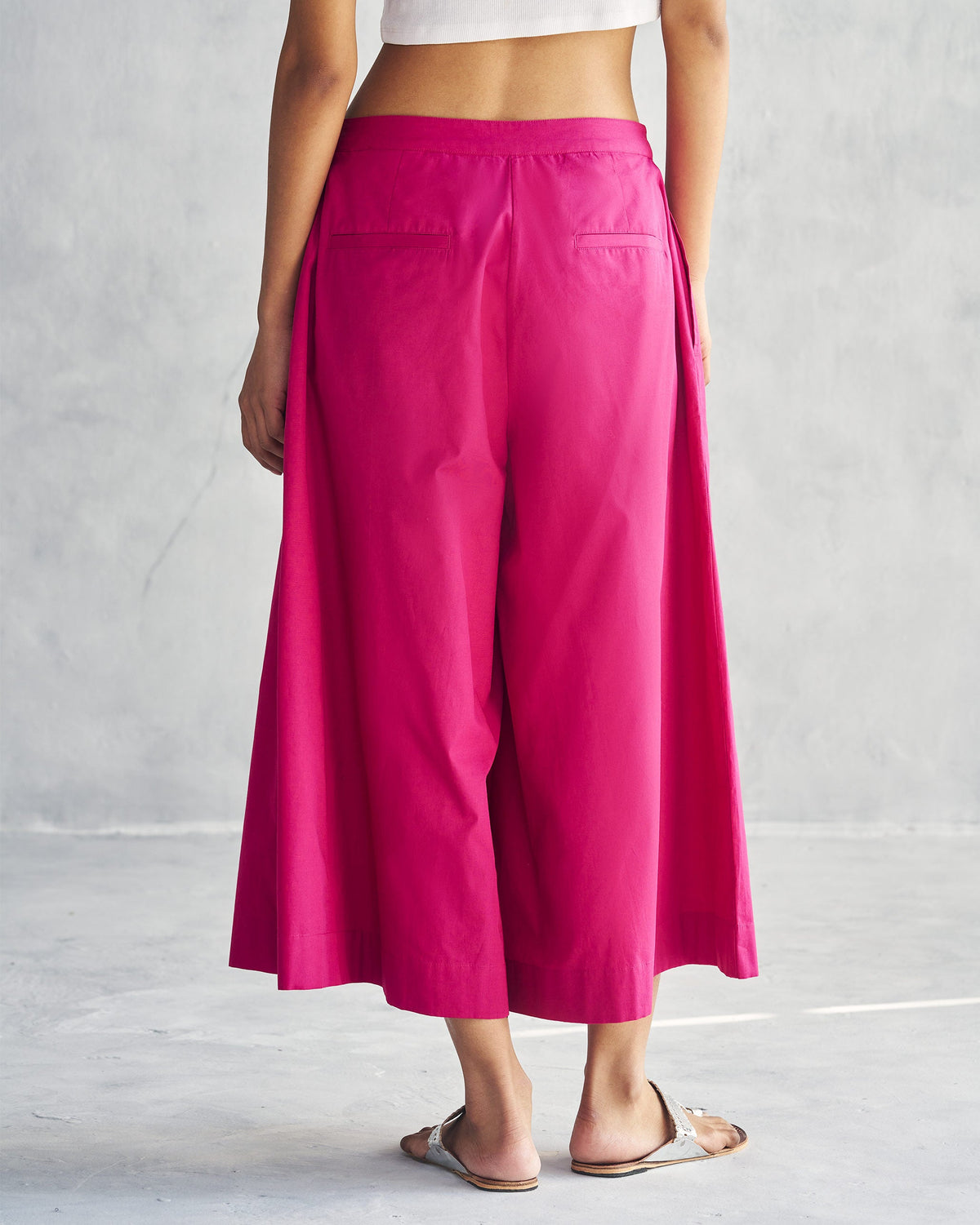 Back of Pleated Flare Culottes in berry worn by a person.