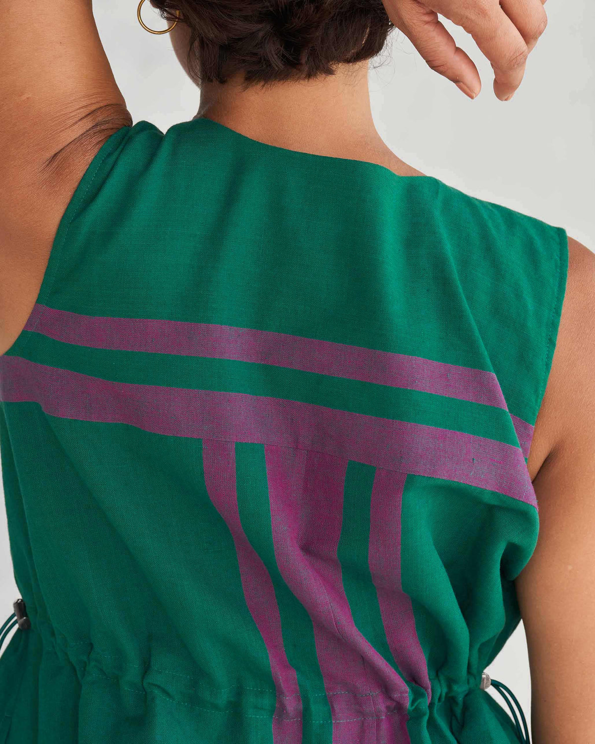 Close-up of purple stripe print on the back of a green Midori dress.